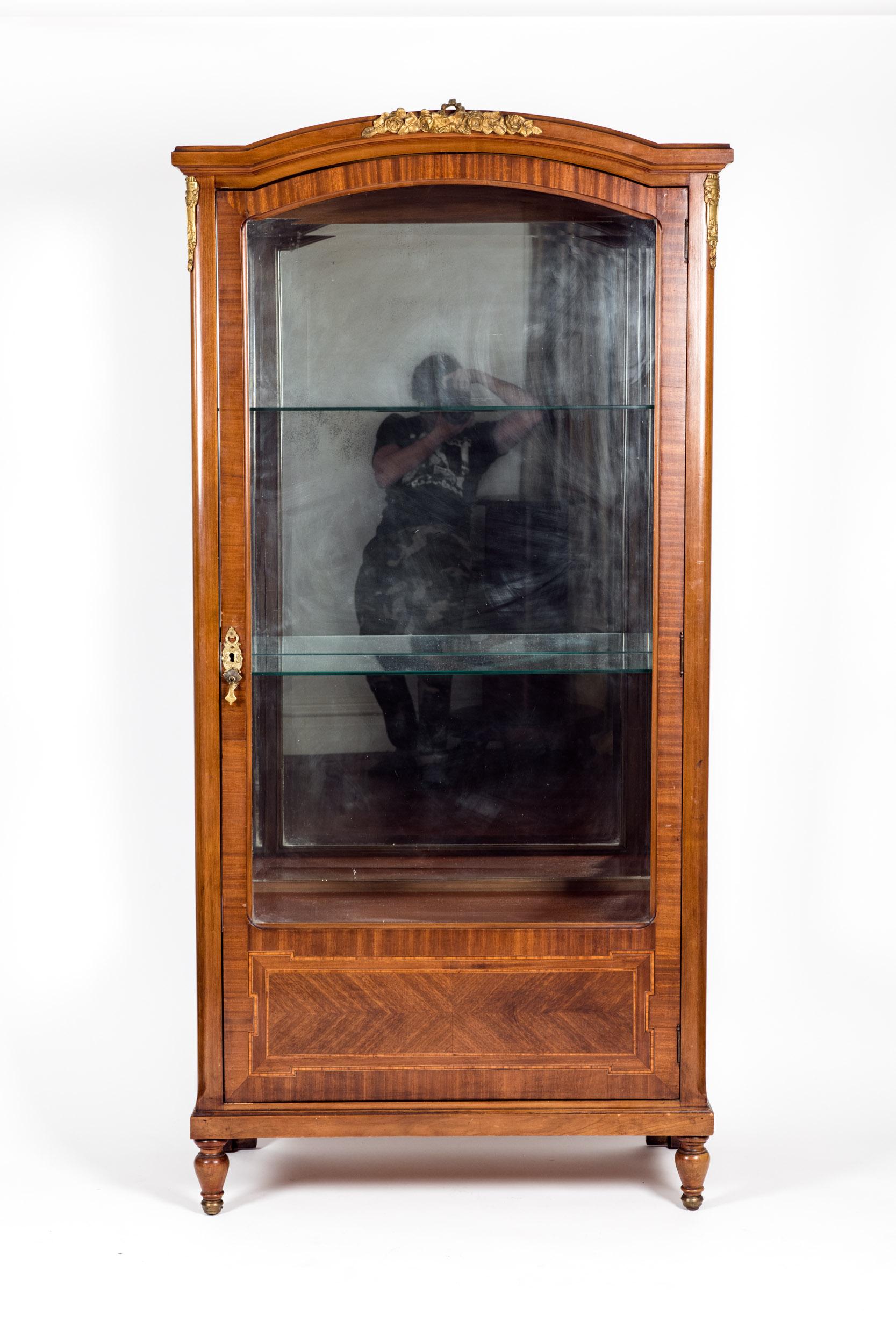 Late 19th century French burl wood vitrine / cabinet with applied bronze details and interior glass shelves. The cabinet / vitrine is in good antique condition with wear consistent with age / use. The cabinet stand about 71 inches high X 35 inches