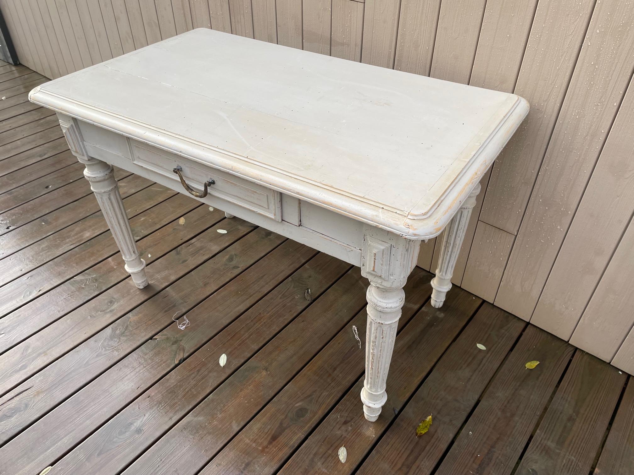 Very nice Late 19th century French butcher table. Used to be a side table in a butcher's shop. Beautiful wood cutting on the sides. 
A drawer in the middle with a brass handle. 
Some worms holes but the table has been treated and has a good