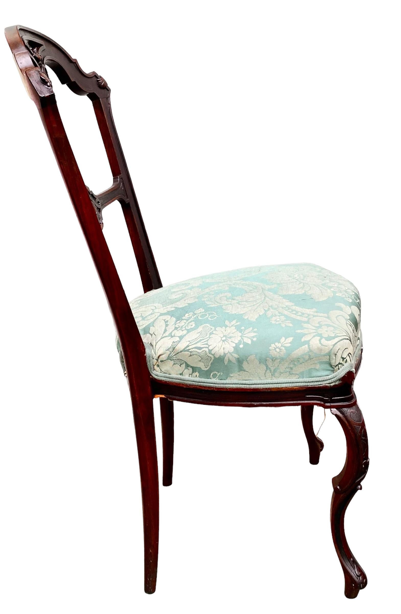 An antique, late 19th century French Belle Epoch, intricately hand carved mahogany accent/side chair, with the most graceful, double scrolled, Cabriole legs. The Belle Epoch period in France was a golden age of great prosperity, beauty and pride.