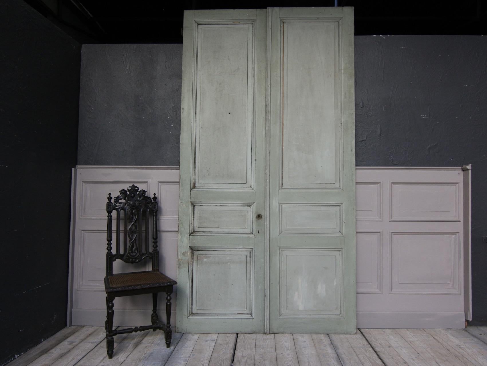 A French double door from the late 19th century or early 20th century. Each door constructed with 3 panels. 
Unrestored condition. 

Dimensions: 
260 cm high / 102.36 inch high,
71 or 139 (together) cm wide / 27.95 or 54.72 inch wide,
3.6 cm