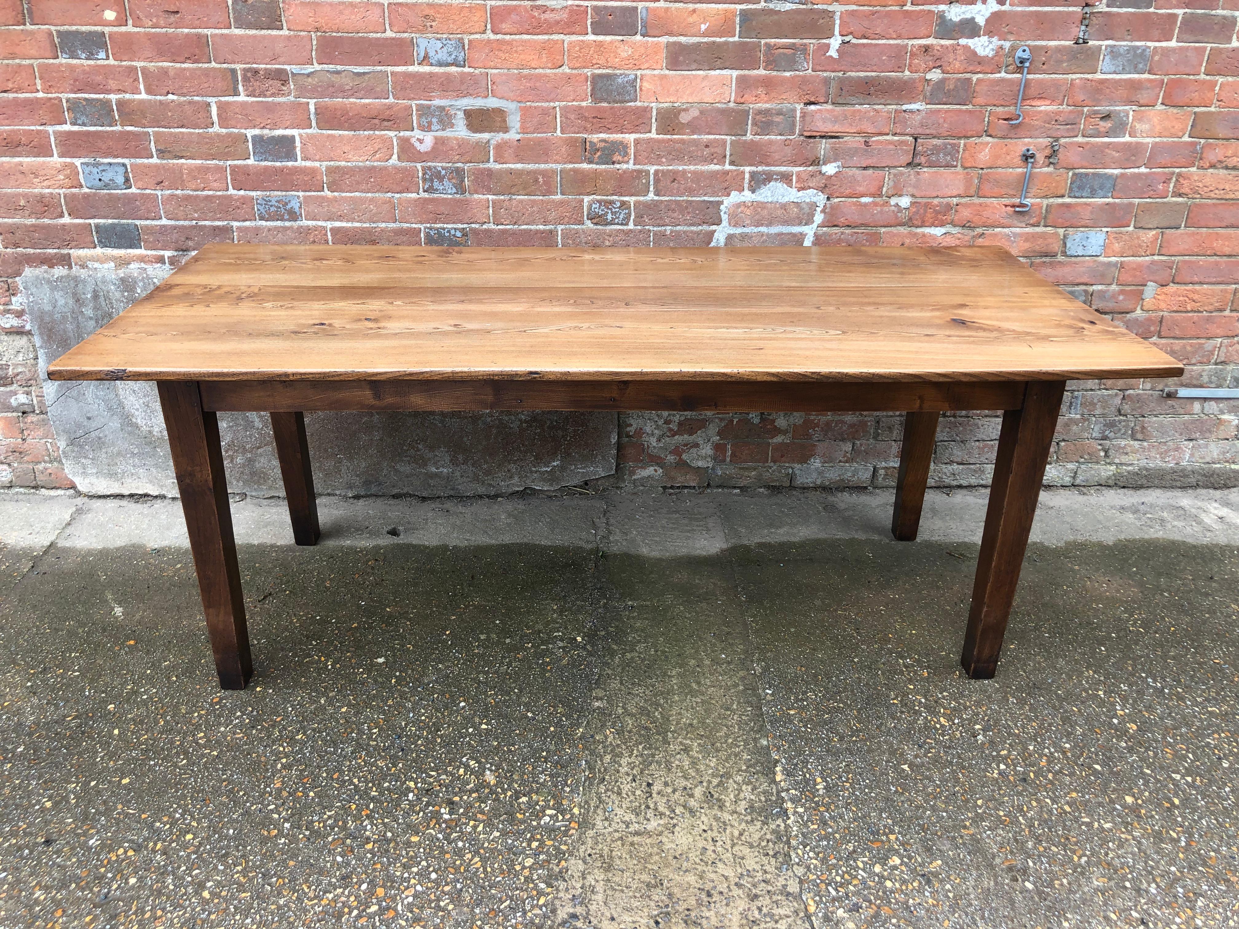 Handsome late 19th century French pale elm farmhouse table, with a central drawer on square tapering legs. Exceptional color and figuring. This table has been restored, re-polished and given a practical, hard wearing finish by one of the finest
