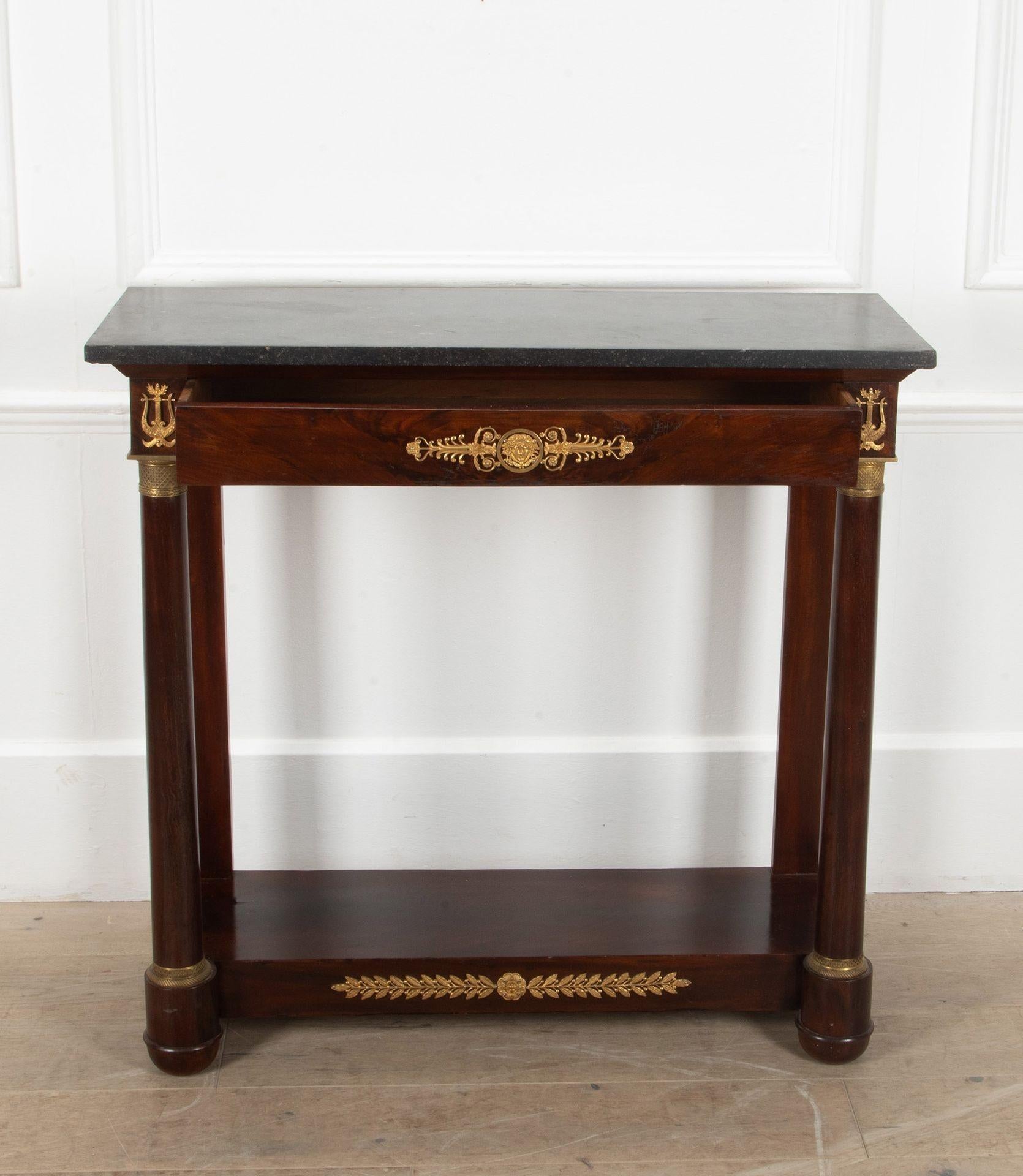 A nice quality late 19th Century French Empire console table.

Made from flamed Cuban mahogany. 

With its original Belgian bluestone top and original ormolu mounts. 