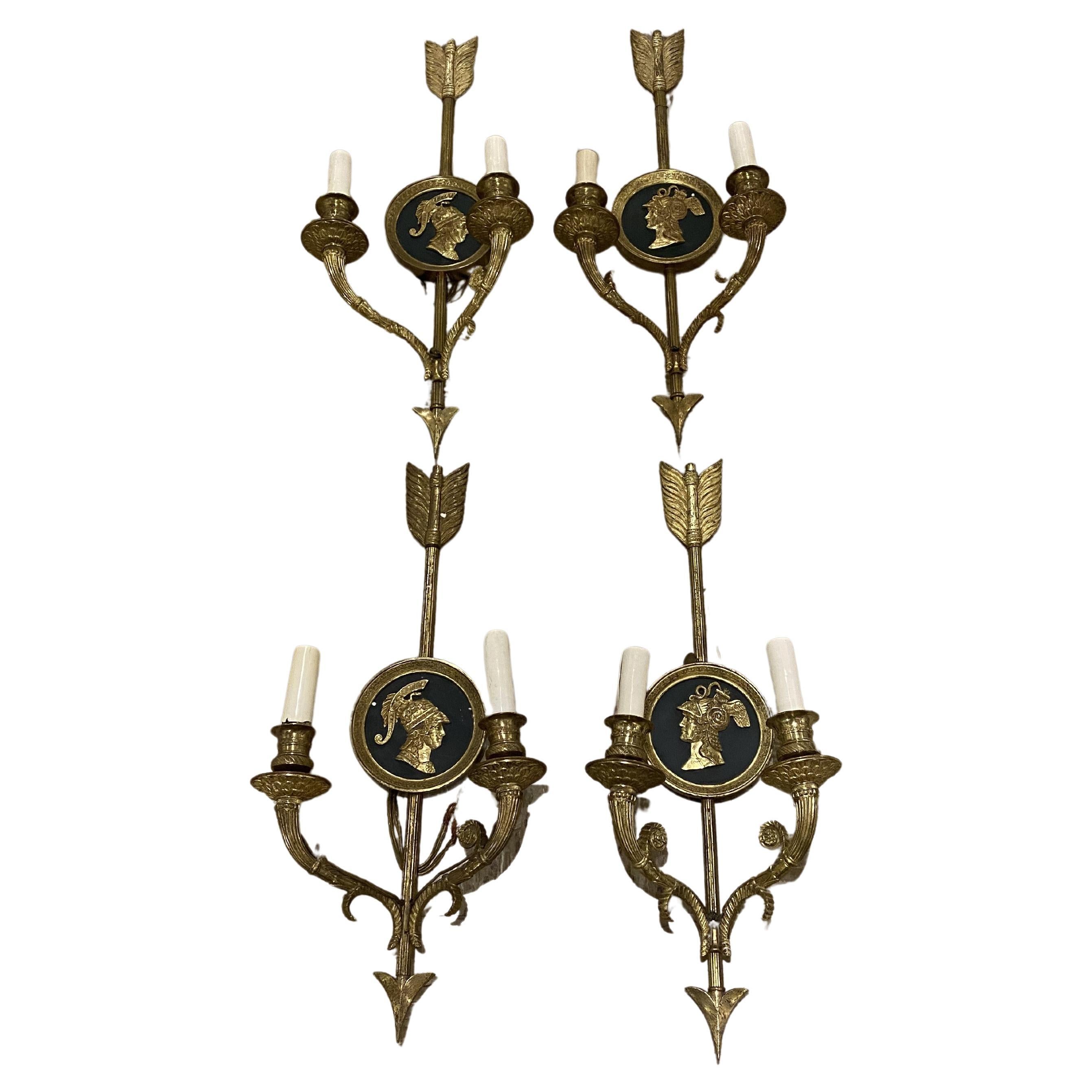 A pair of circa 1900's Empire style sconces with two Roman warriors on black backplate.