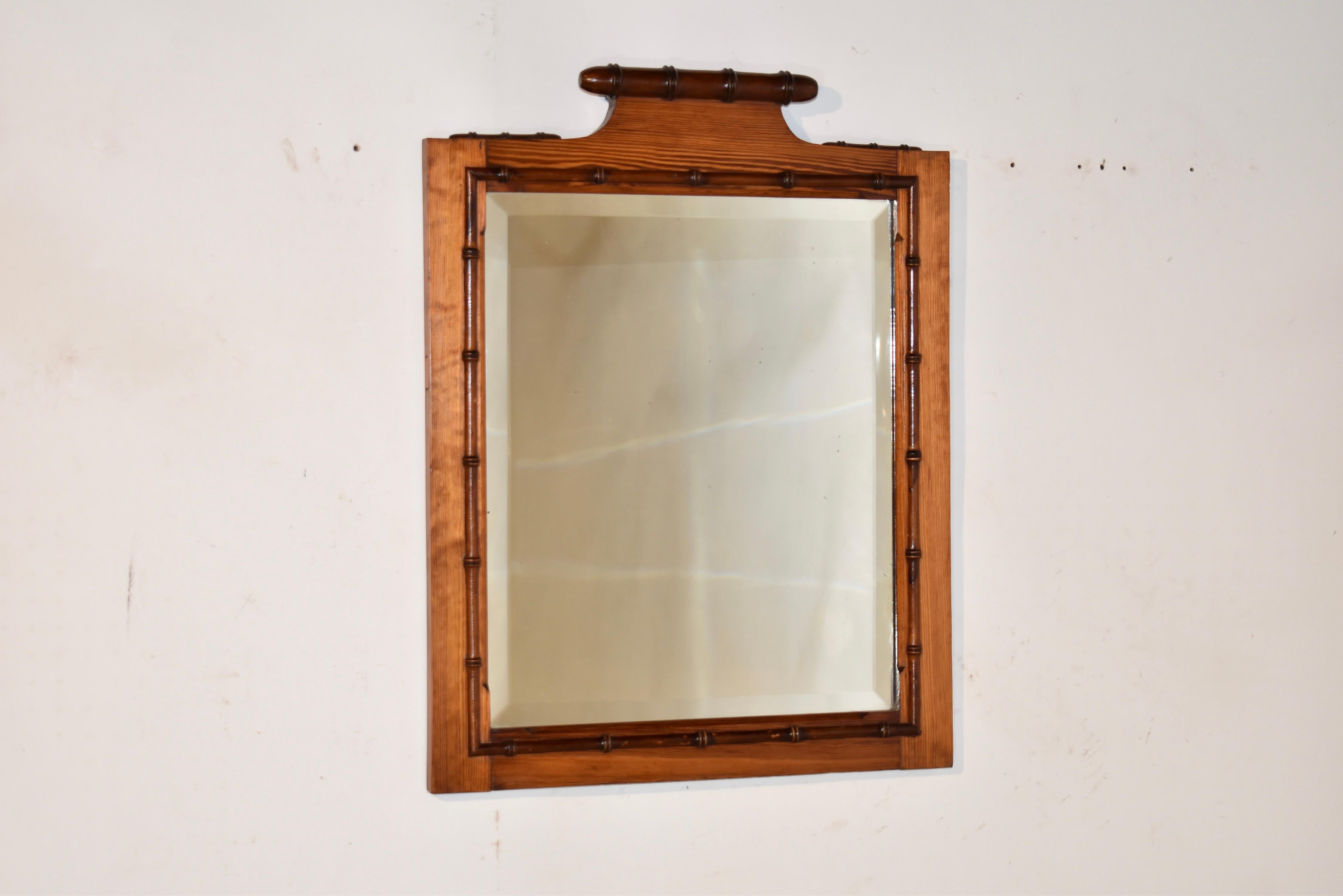 Late 19th century French wall mirror made from pitch pine and cherry.  The frame is made from pitch pine, which has a richer and developed grain pattern than regular pine.  All of the turnings are made from cherry and have been applied to this