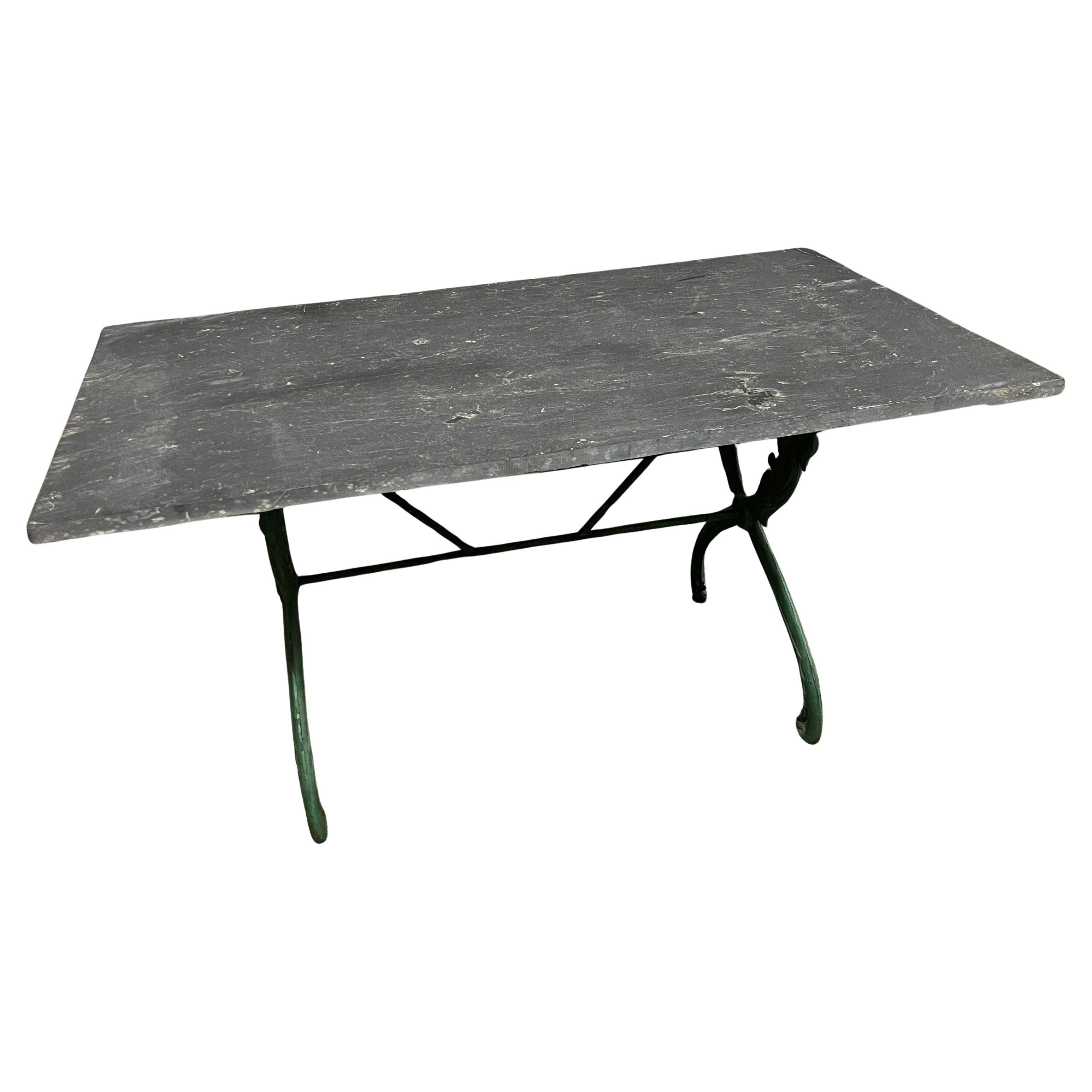 A very lovely later 19th century garden table from the South of France beautifully constructed with a painted iron base and a slate top. The legs are decorated with lovely swans. Perfect for any interior or exterior environment.
