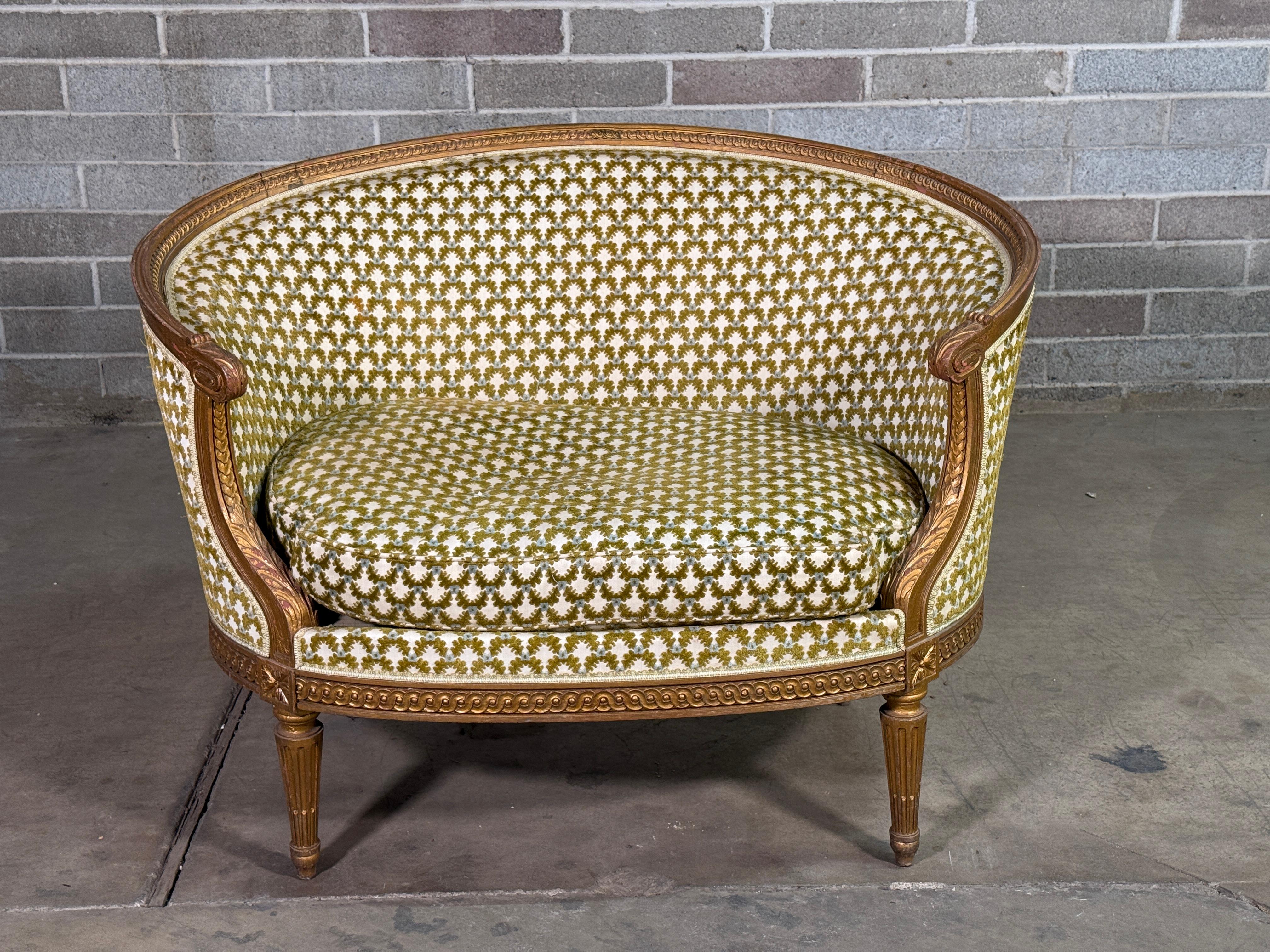 Late 19th Century French Giltwood Petite Settee 
Guilloche Carving and Fluted Tapered Legs 
Beautiful piece purchased in France. 
Age appropriate wear, see detailed photos. 
