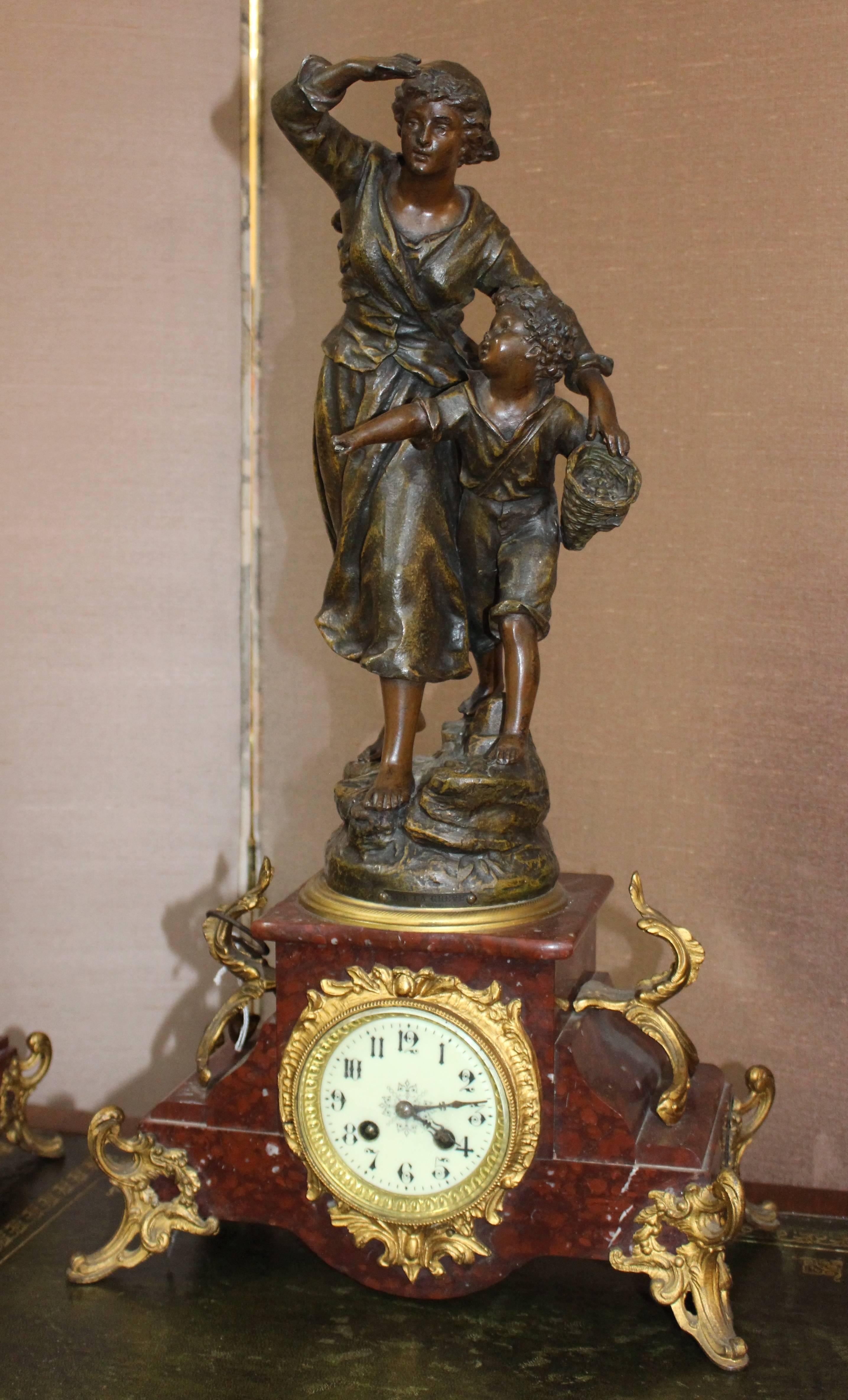 Type French garniture clock set
Period late Victorian
Decoration spelter figure on marble base surmounted by two spelter and marble urns
Movement 8 day movement, striking on a bell on the hour and half-hour
Dial enamel dial with Arabic numerals,