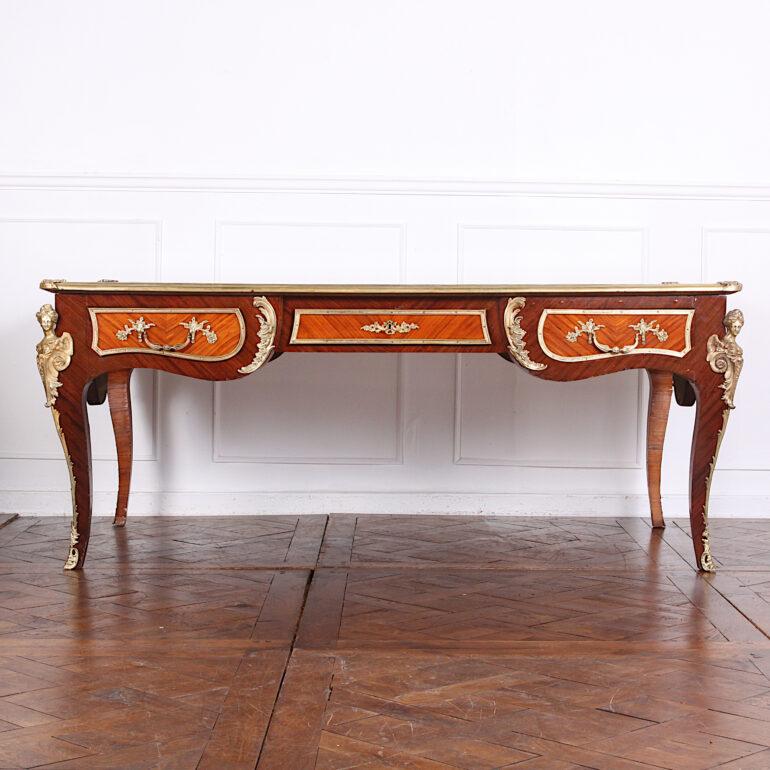 Fit for a French Aristocrat. A large and impressive Louis XV Kingwood and mahogany bureau plat the case featuring finely-detailed gilt bronze mounts and with newly-fitted gilt tooled leather writing surface. Dating to the late 19th century, this