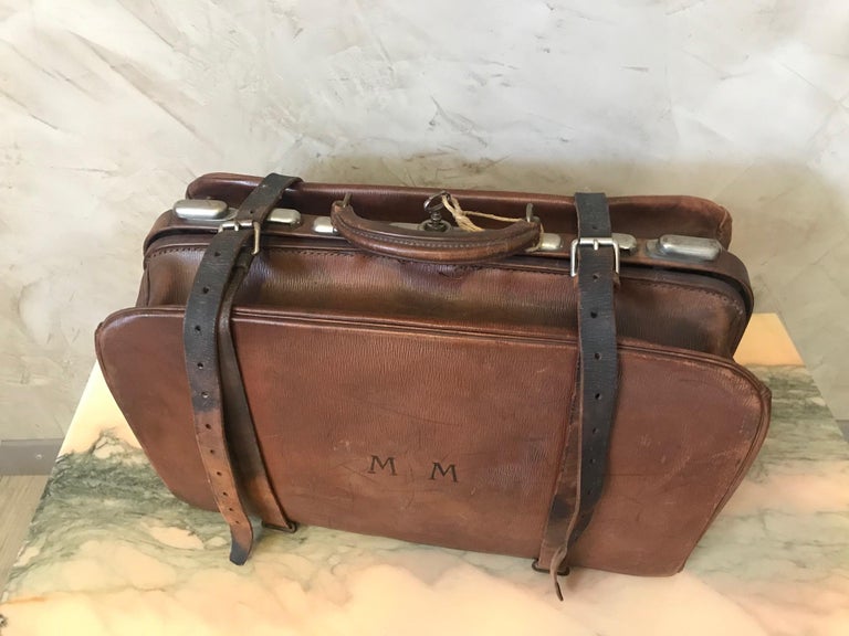 Beautiful late 19th century French Leather travel suitcase from the 1890s. 
Original key. Metal fittings. 
Two leather thongs. MM initials on the front. 
Push on the key to open the case. 
Inside, pocket to put documents. Nice quality. 
Leather