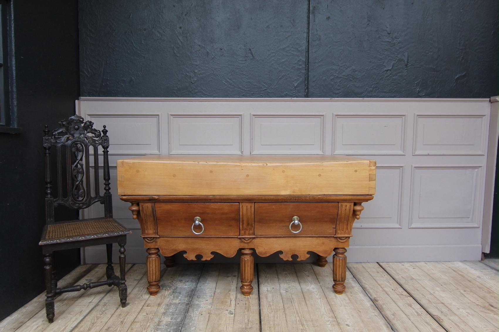 French Louis Philippe billot de boucher or butcher's block from the late 19th century. 

Standing on 5 reeded legs with a beautifully carved scalloped apron between and two large drawers with ring pulls. The heavy tabletop has been already