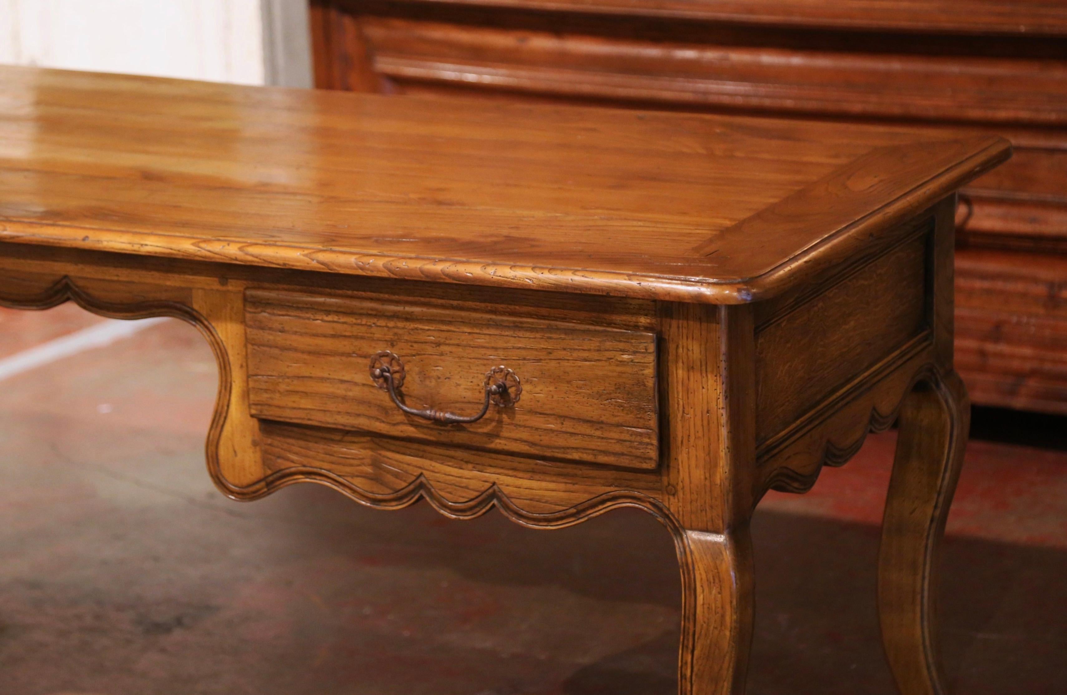 This elegant antique fruit wood desk was created in the Poitou region of France, circa 1880. Made of chestnut timber and rectangular in shape, the writing table sits on four cabriole legs, over a scalloped apron decorated with hand carved floral and