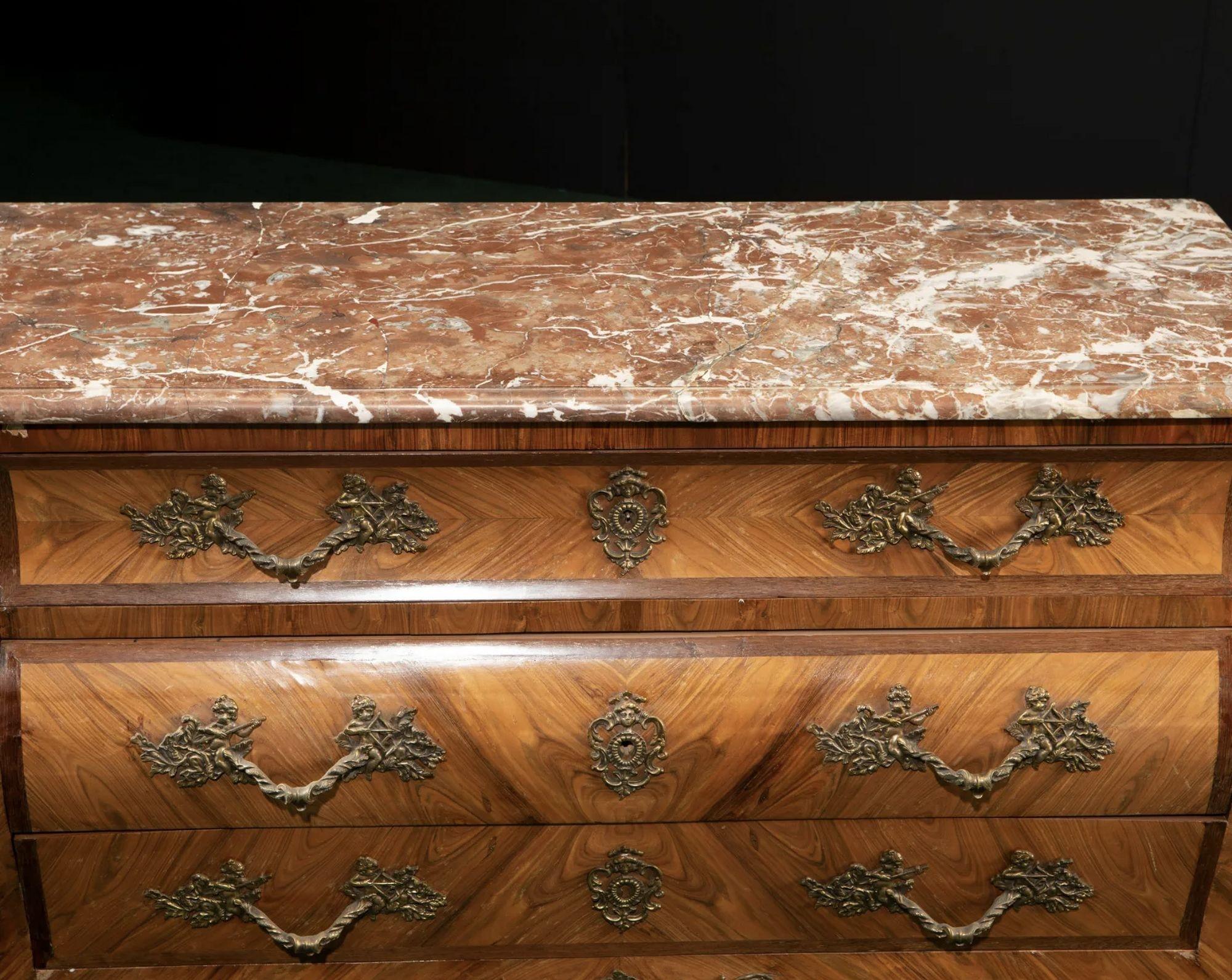 Late 19th century French Louis XV-style Bombe Commode
 
The book matched veneered chest with marble top over three drawers with bronze mounts and hardware
 
Dimensions:
 
33.75