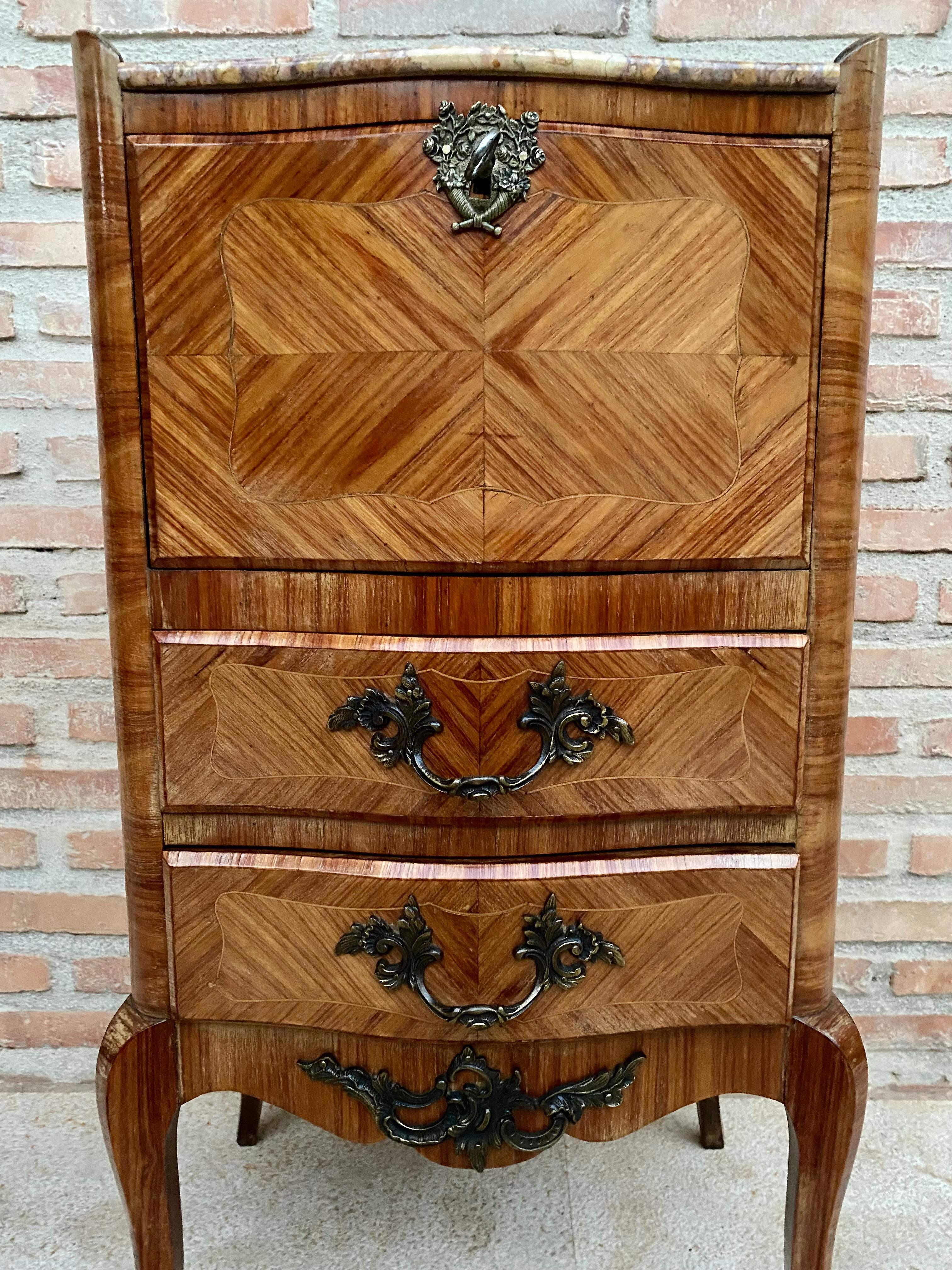 Beautiful French Louis XV style walnut marquetry from the late 19th century and marble chest of drawers from the 1890s. 
Marble top, beautiful marquetry on the drawers and on all sides of the dresser. 
It has a front hinged door with a bronze lock