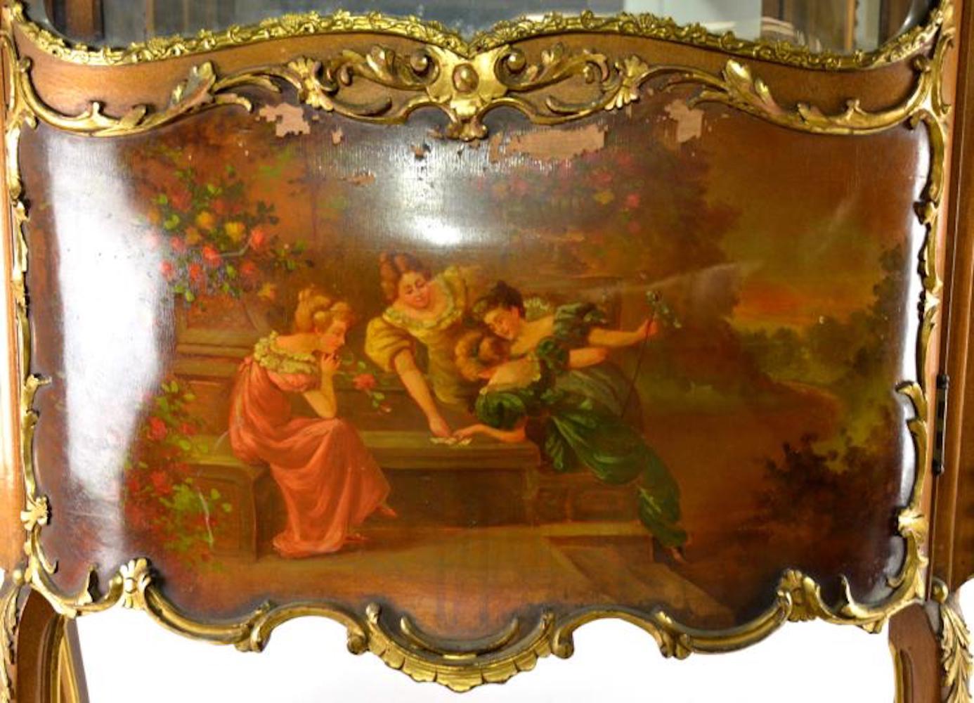 Late 19th century; 76.5 inches height x 37 inches width x 16 inches depth; has beautiful gold gilt press, with hand painted cherubs, has gold gilt ormolu mouse throughout, mirrored back, beautiful artwork of women and gardens, overall condition is