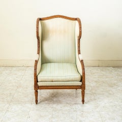 Late 19th Century French Louis XVI Style Hand Carved Walnut Wingback Armchair