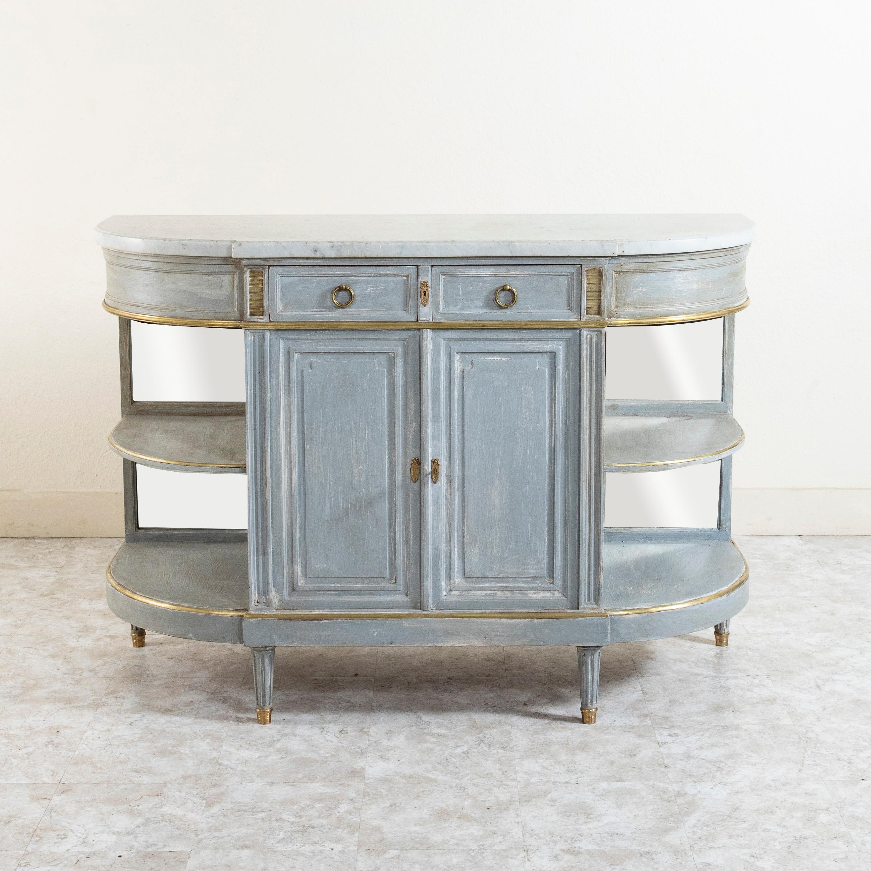 This late nineteenth century French Louis XVI style demi-lune enfilade, sideboard, or buffet features a beveled white marble top and bronze detailing. Painted in Marie Antoinette grey, this piece has two drawers of dovetail construction fitted with