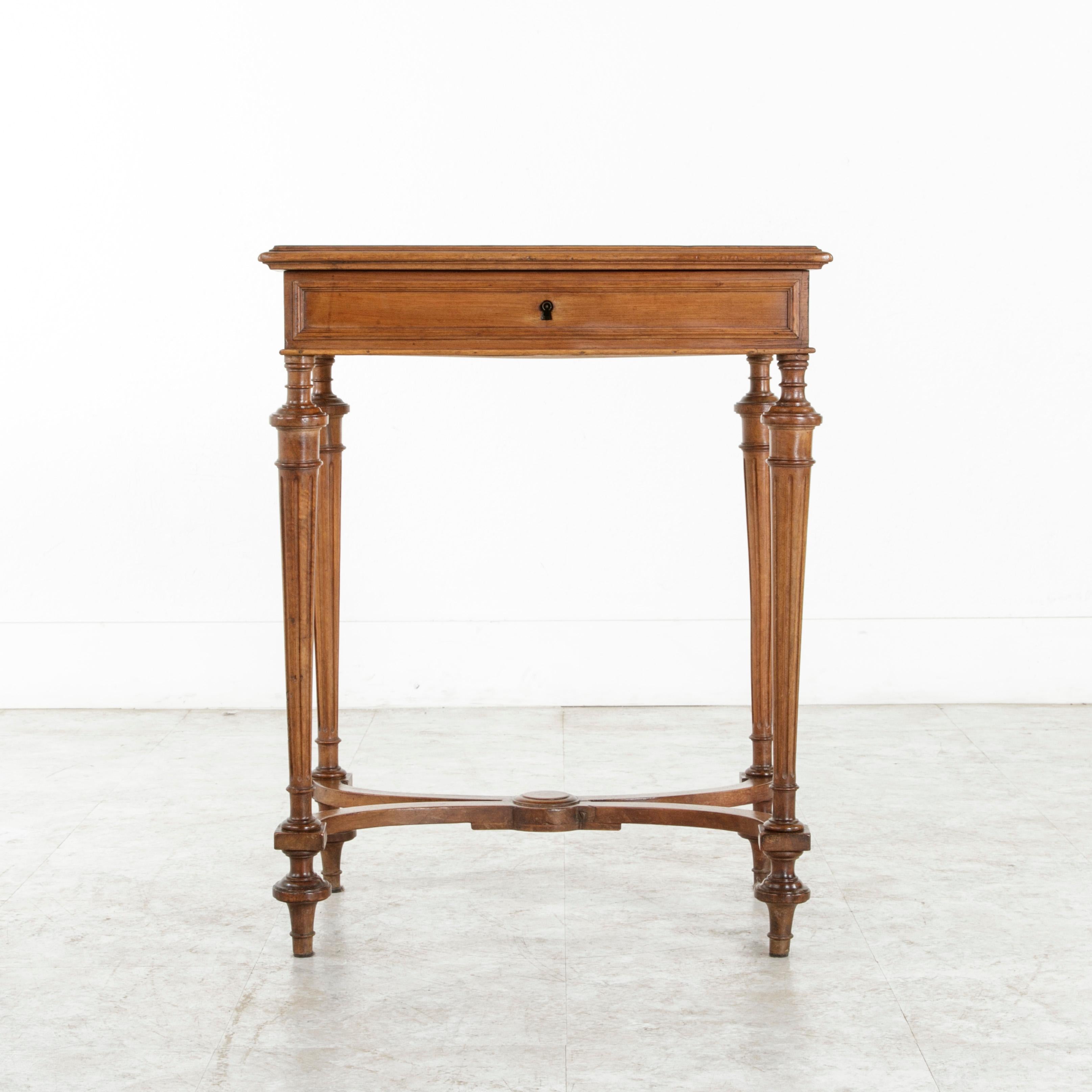 This late-19th century French Louis XVI style side table constructed of solid walnut is called a 