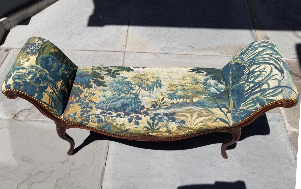 This Classic Louis XVI window bench is carved walnut with rosettes, bellflowers and stop fluting. This tapestry shows a nature scene.

Additional measurements:
Arm height 26.75 inches
Seat height 19 inches.