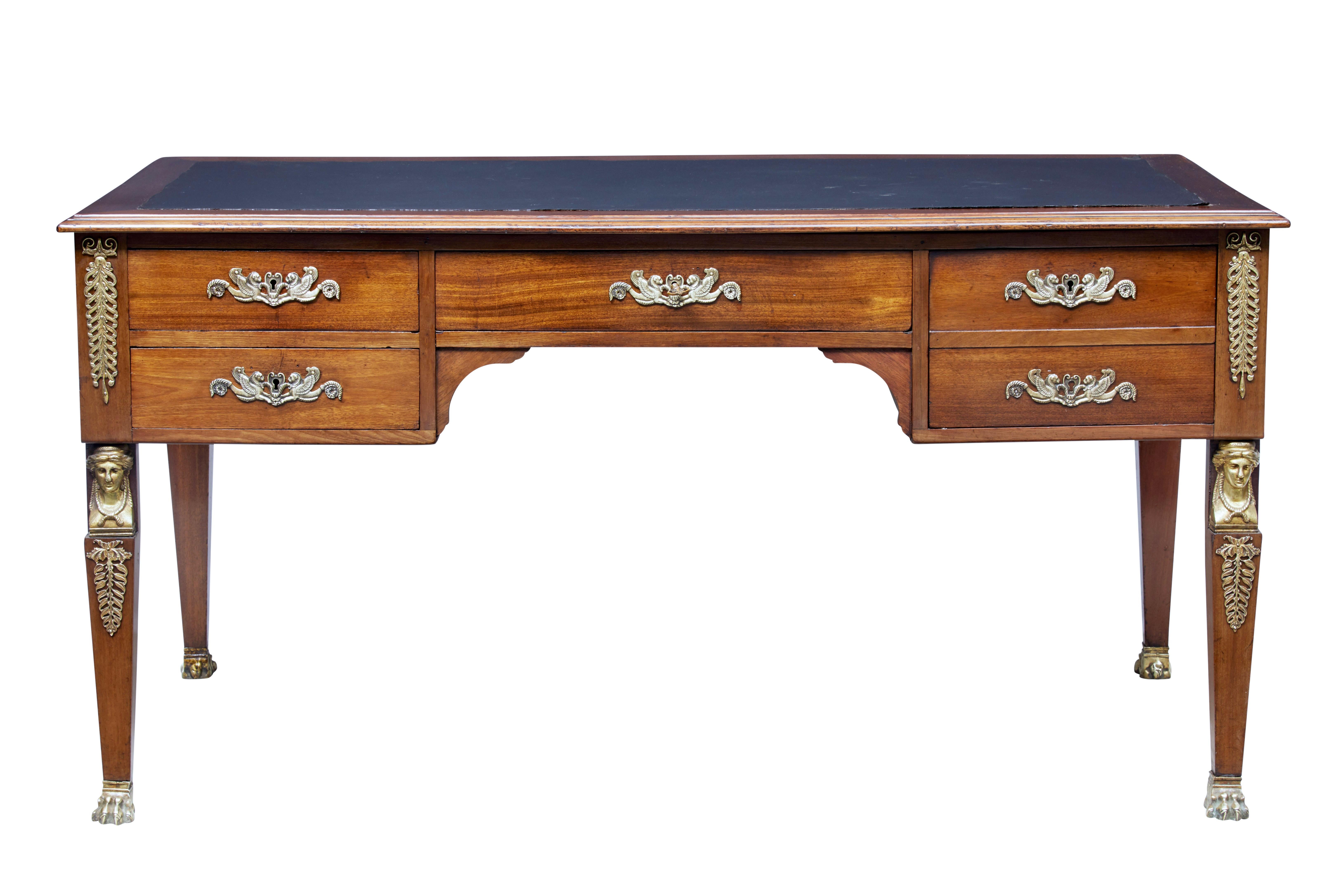 Large mahogany French Empire desk, circa 1890.

Simple elegant freestanding desk adorned with ormolu mounts. 1 drawer above the knee and 2 drawers either side which open on the key. Reverse side with dummy drawers and further mounts. Egyptian
