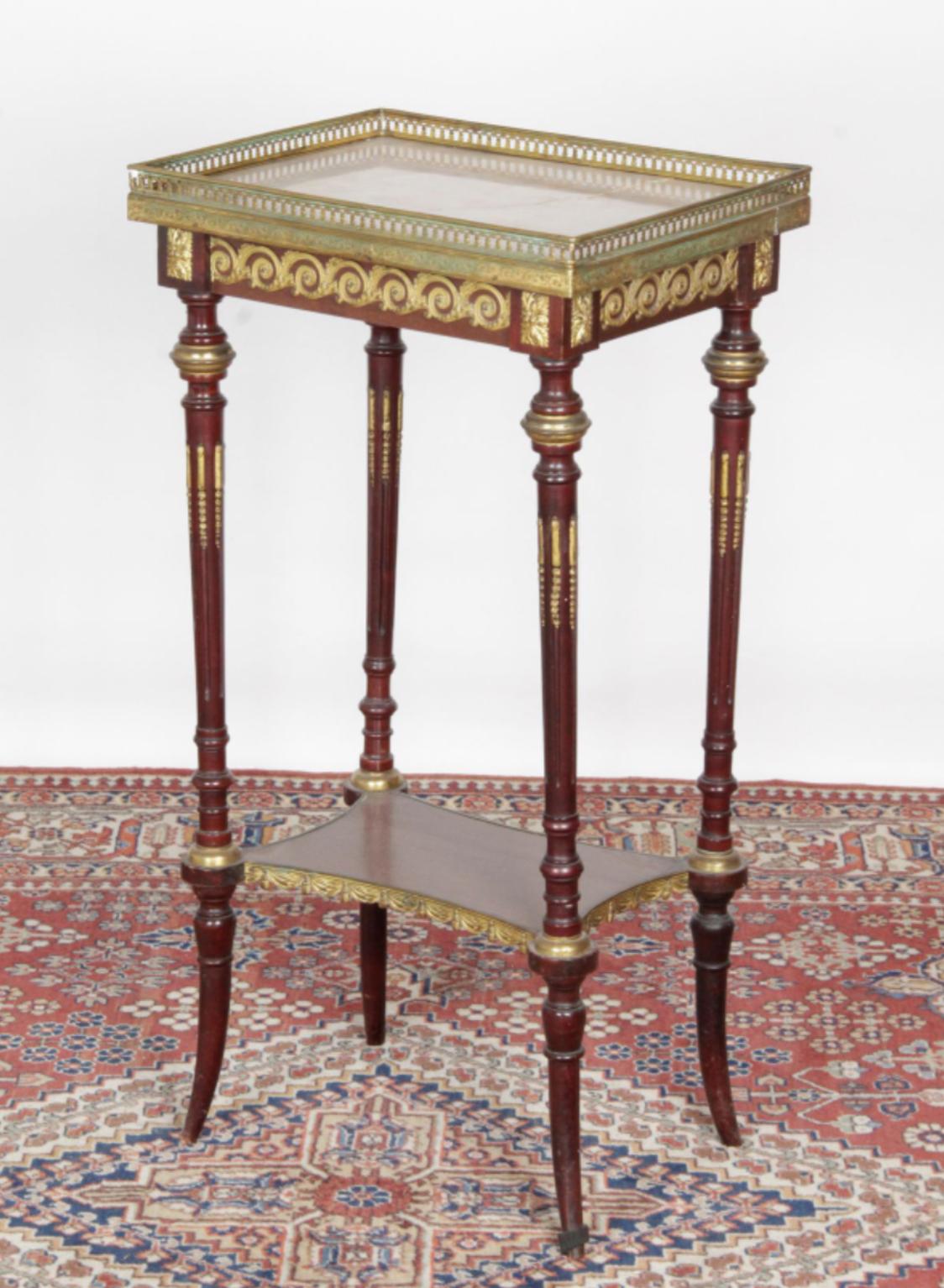 French side table in white marble plate square top and gallery, the four tapered and fluted uprights joined by a crotch shelf and finished with diverging legs. Chiselled and gilded bronze ornamentation such as rings, foliated sconces and post