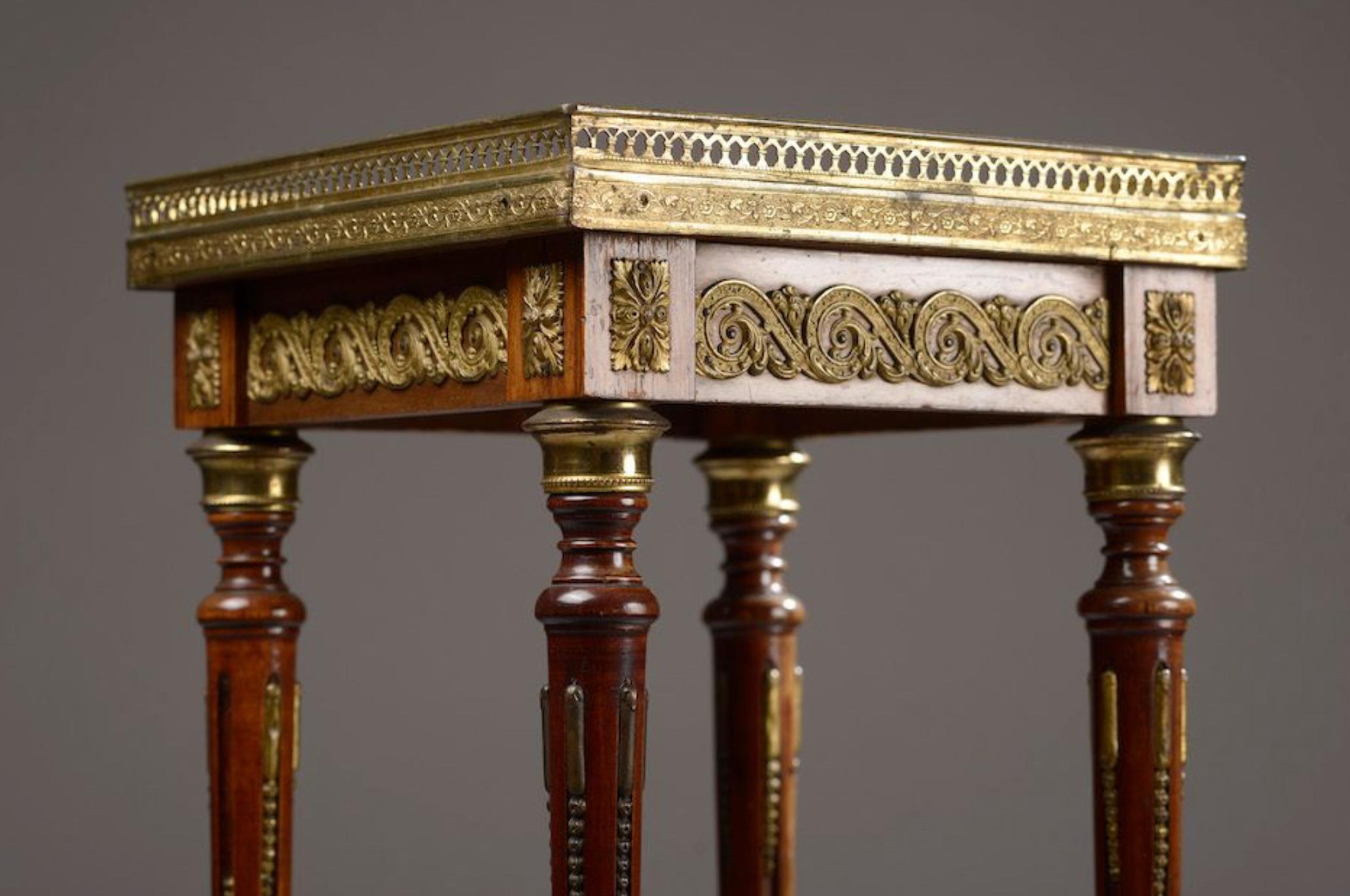 French side table in dark onyx plate square top and gallery, the four tapered and fluted uprights joined by a crotch shelf and finished with diverging legs. Chiselled and gilded bronze ornamentation such as rings, foliated sconces and post