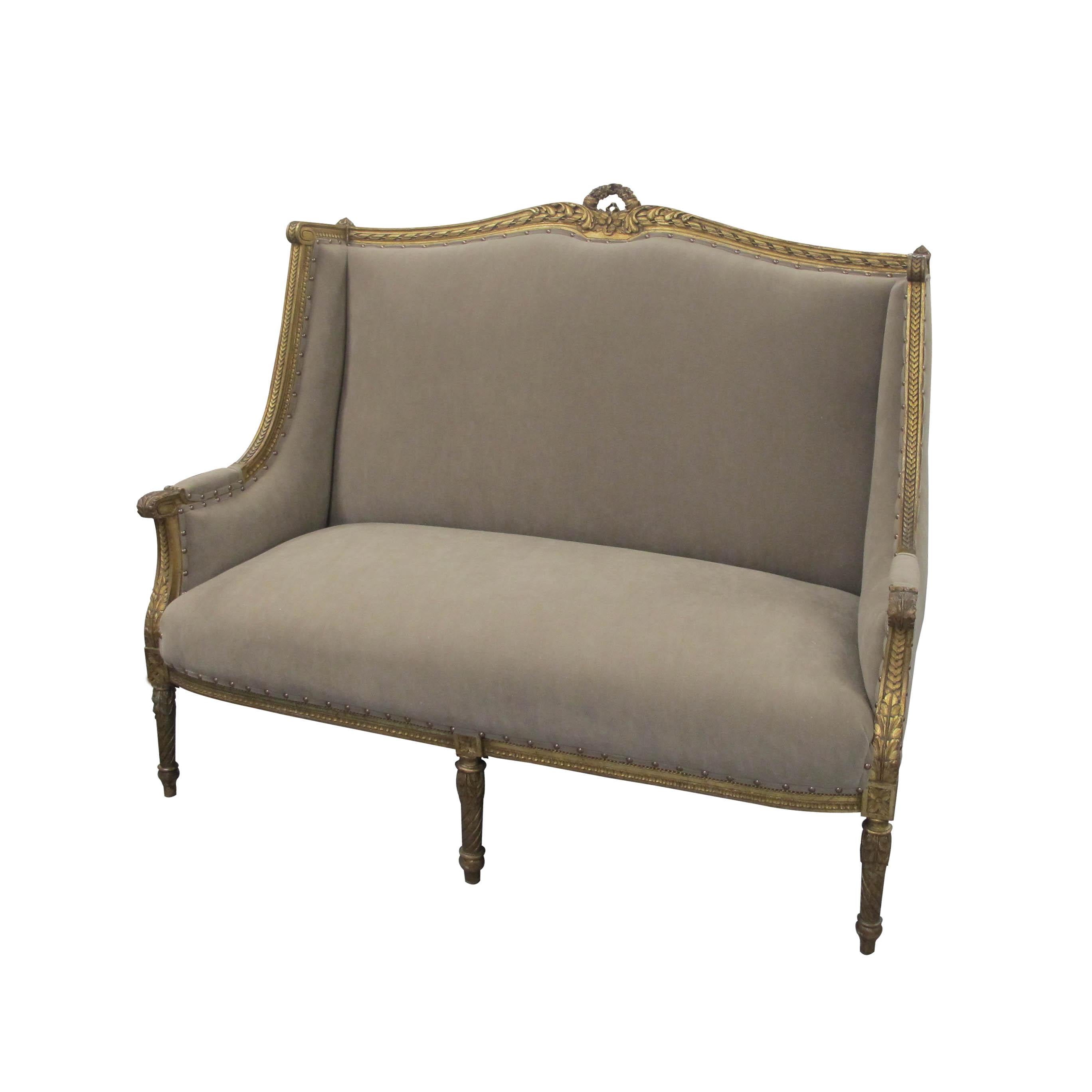 A generous high-backed two-seat French marquise, circa 1880 Louis the XVI style sofa. Newly upholstered with a suede like Impala fabric, in a light brown color, with antiqued studs, easy to clean and very resistant. The Marquise boasts very elegant