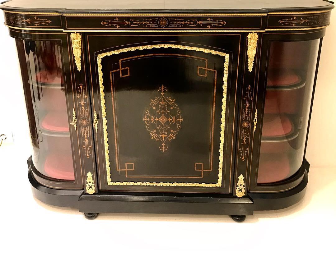 French Napoleon III demilune form sideboard cabinet totally ebonized elegantly decorated with wood inlay bronze mounts and velvet interior. On both sides is vitrine with original door glass.