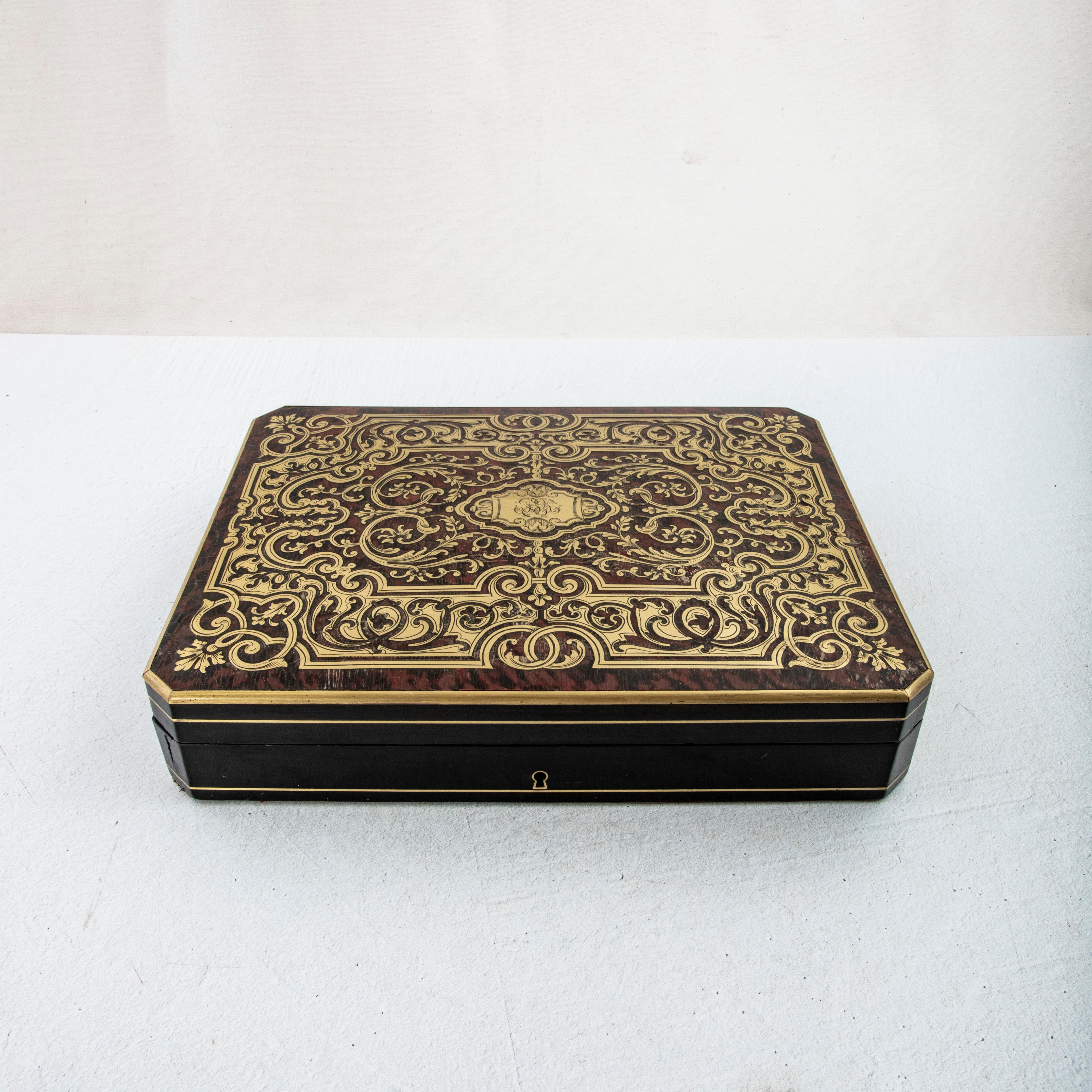 Once owned by Leon Boissier Palun (1916-2007), former Senegalese ambassador to London and Paris, this mid nineteenth century French Napoleon III period palisander game box features a tortoise shell inlaid lid with intricately scrolling bronze inlay