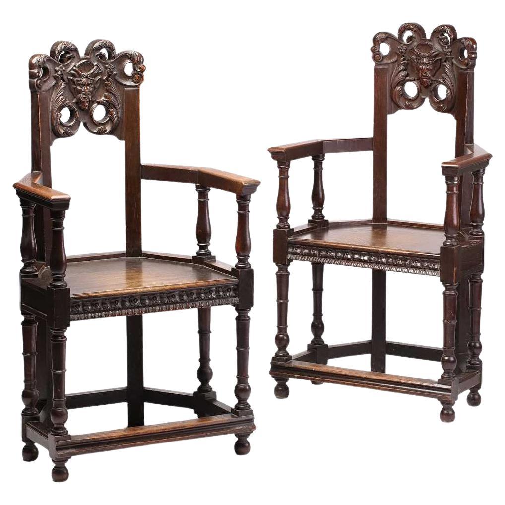 Late 19th Century French Oak Caquetoire Grotesque Pan Carved Armchairs  For Sale