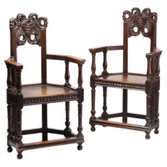 Late 19th Century French Oak Caquetoire Grotesque Pan Carved Armchairs