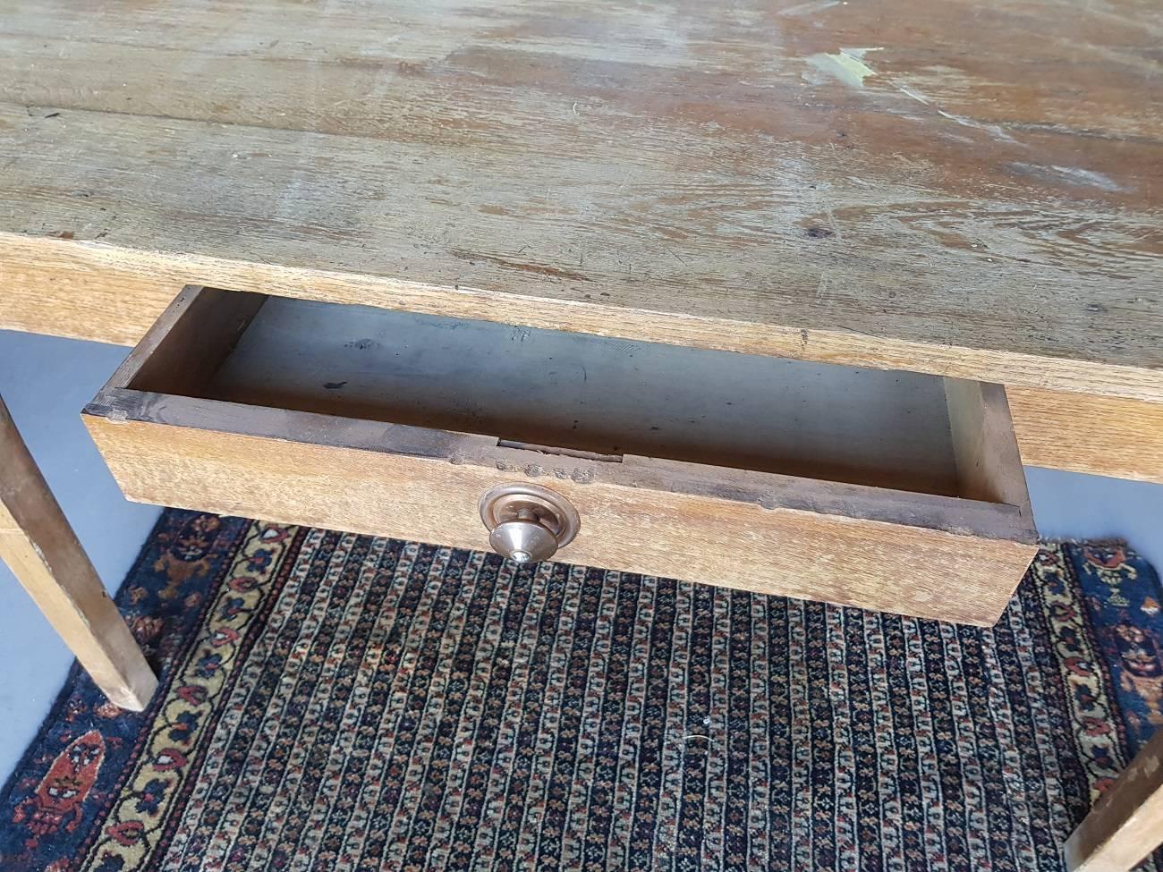 Beautiful and wear by age and use this late 19th century French oak kitchen table with one drawer with a copper button.

The measurements are:
Depth 78 cm/ 30.7 inch.
Width 129.5 cm/ 50.9 inch.
Height 75 cm/ 29.5 inch.
 