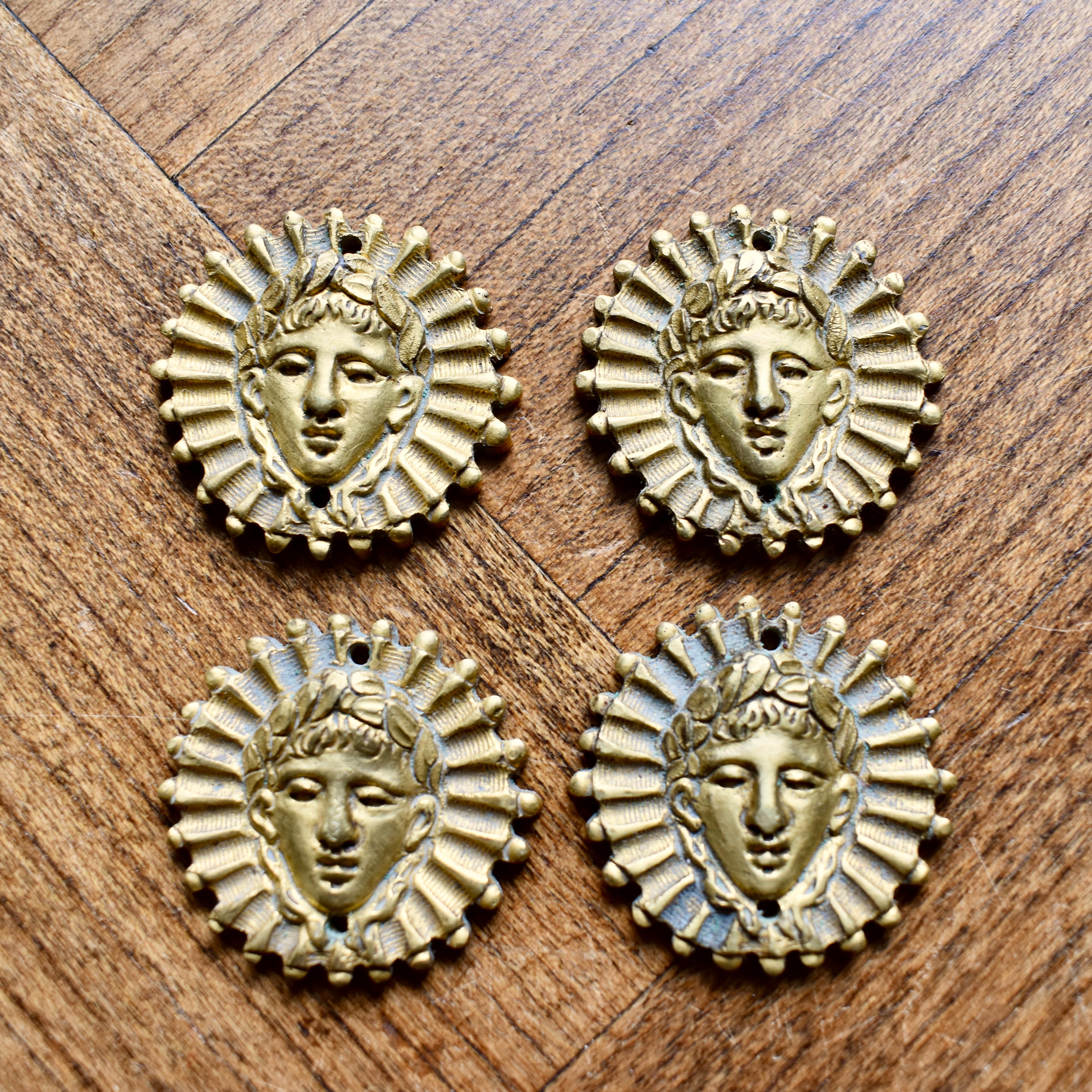 Add an elegant Parisian touch to your decor with this fabulous set of antique French ormolu, Beaux Arts Sun King medallions, circa 1890-1910.

Molded in high relief with the head of Louis XIV, known as Louis le Grand or Roi Soleil, the Sun King.