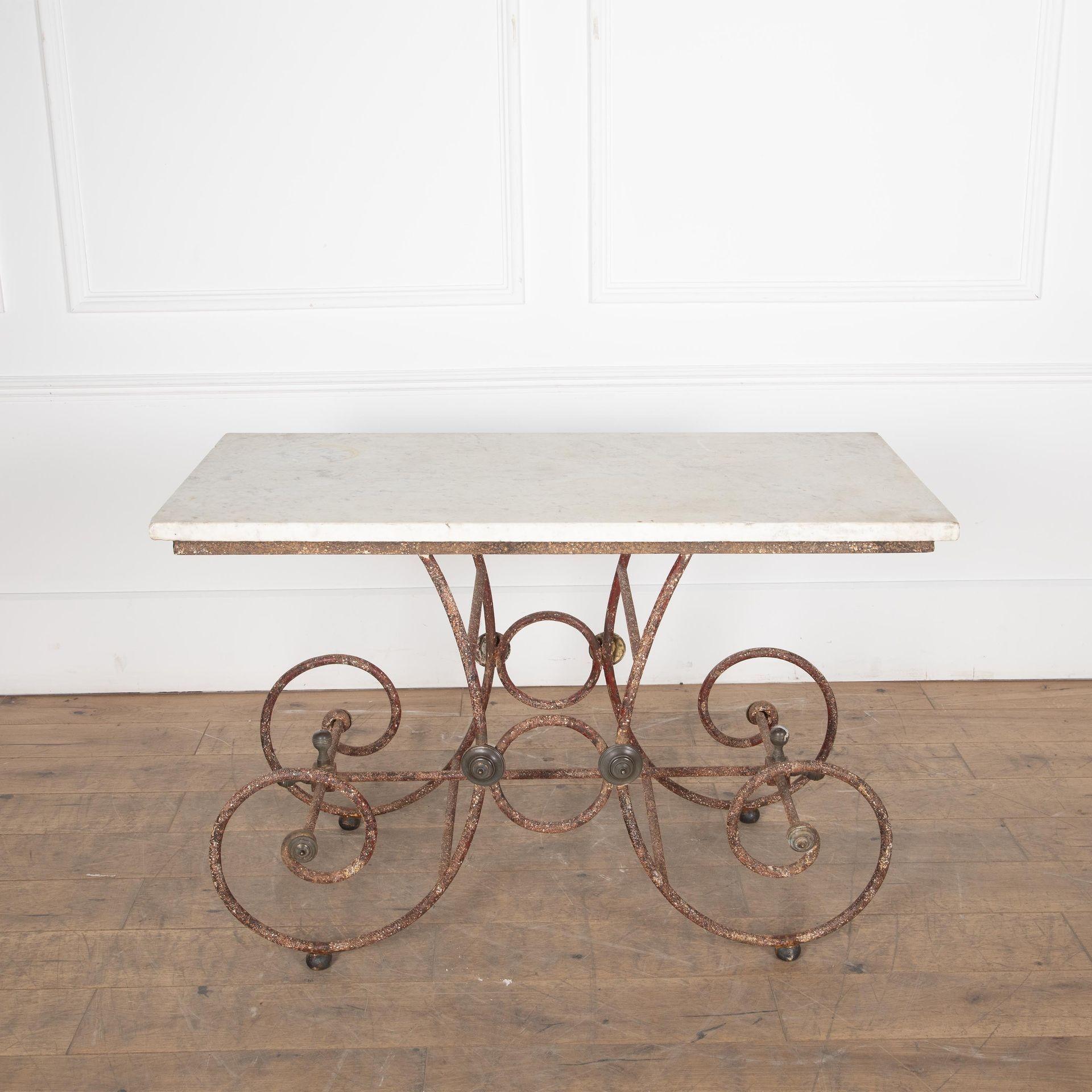 Elegant 19th Century French patisserie table.

Beautiful original marble top sitting on scrolling wrought iron base with brass roundels.

Pâtisserie tables were designed to go in the shop window and display edible goods.

Therefore, a beautiful