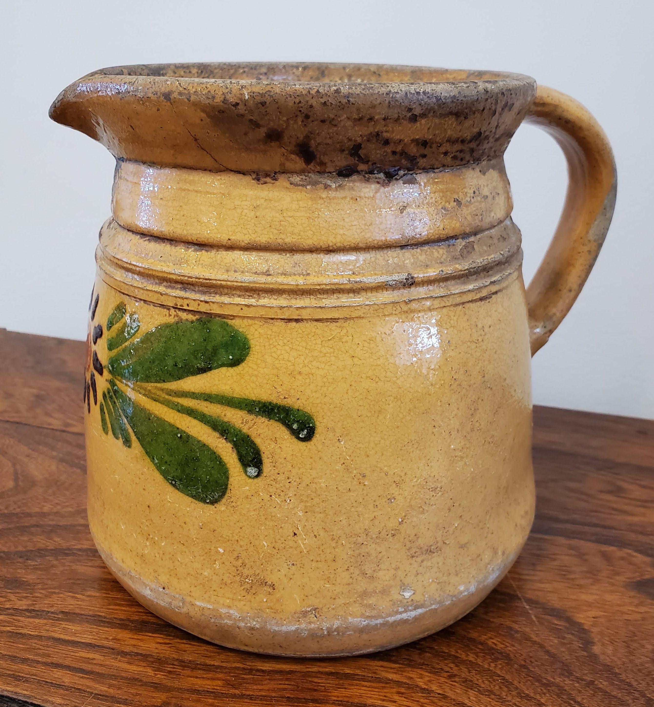 Unusually Large French Provincial Terra Cotta Cream Pitcher or Wine Jug. With brown glaze and polychrome floral decoration. Simple rustic charm. 
Savoie region of France, circa 1880
Measures: 7” H, 6.5” Dia
 