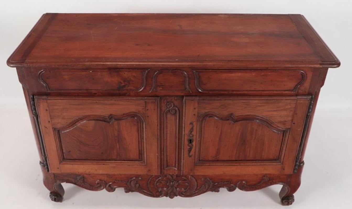 Fine quality 18th century French provincial buffet. Made in the manner of Louis XV. Shaped panels with relief carved mouldings, over two cupboard doors with remarkable carved decoration above a shaped apron with further extraordinary carved and