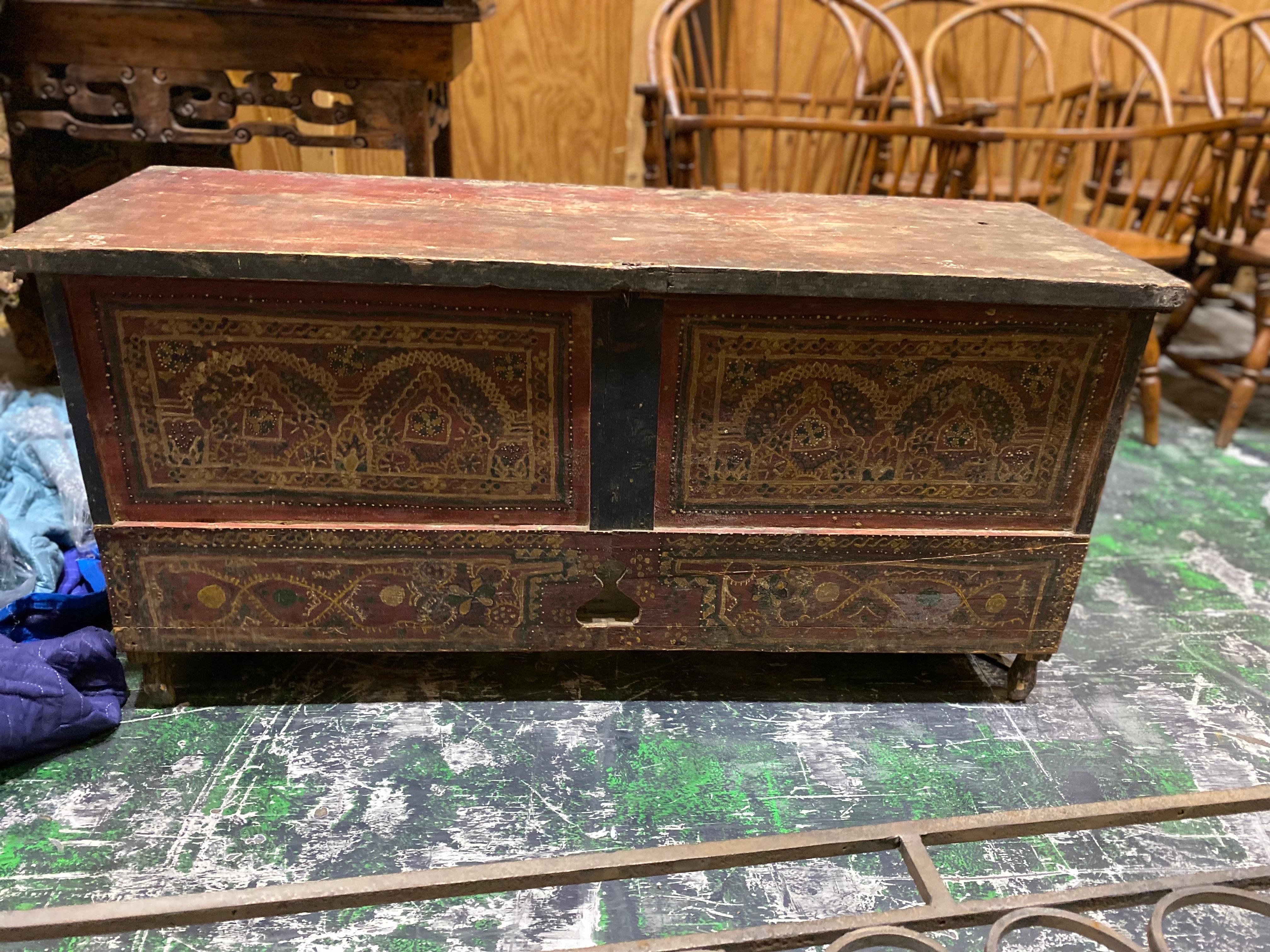 Late 19th century French red painted bench/blanket chest/trunk with elaborate decoration.
A simple wooden rectangular box construction with a worn red painted background color. Elaborate primitive decoration on front and sides of chest in green,