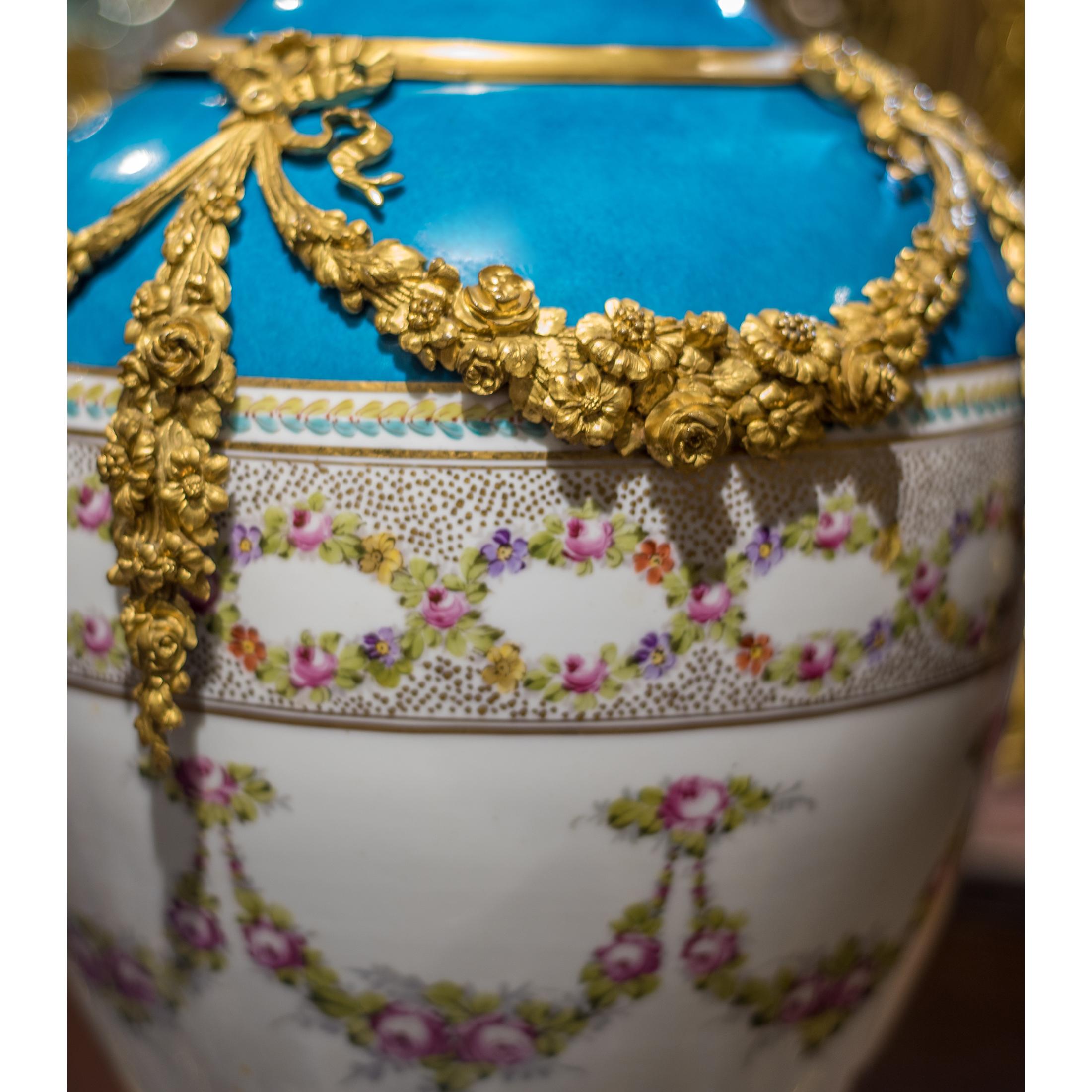 A Fine quality Sèvres-style ormolu-mounted porcelain bleu vase. The oviform vase flanked by ormolu garlands, finely painted floral design.

Date: Late 19th century
Origin: French
Dimension: 28 1/2 x 14 inches.