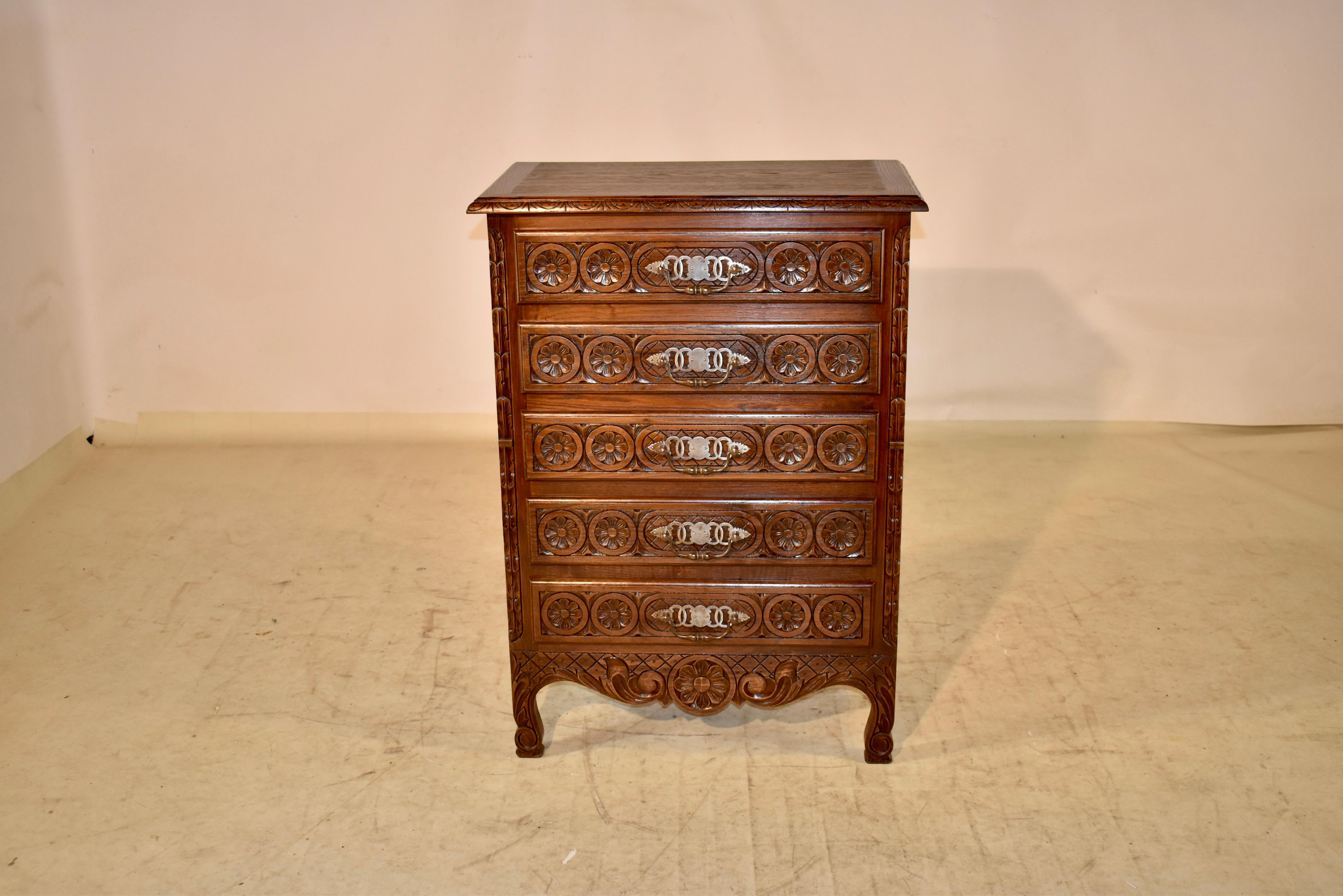 Late 19th century single chest of drawers with a banded top which has a beveled and carved decorated edge, following down to elegantly paneled sides over a scalloped skirt. The case has five drawers with hand carved drawer fronts, flanked by carved