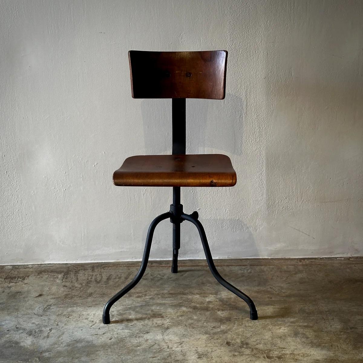 Late 19th-century French adjustable swivel chair combines a bentwood frame with three splayed iron legs, exemplifying classic utilitarian design. This chair not only rotates a full 360 degrees but also allows for height adjustments, providing both