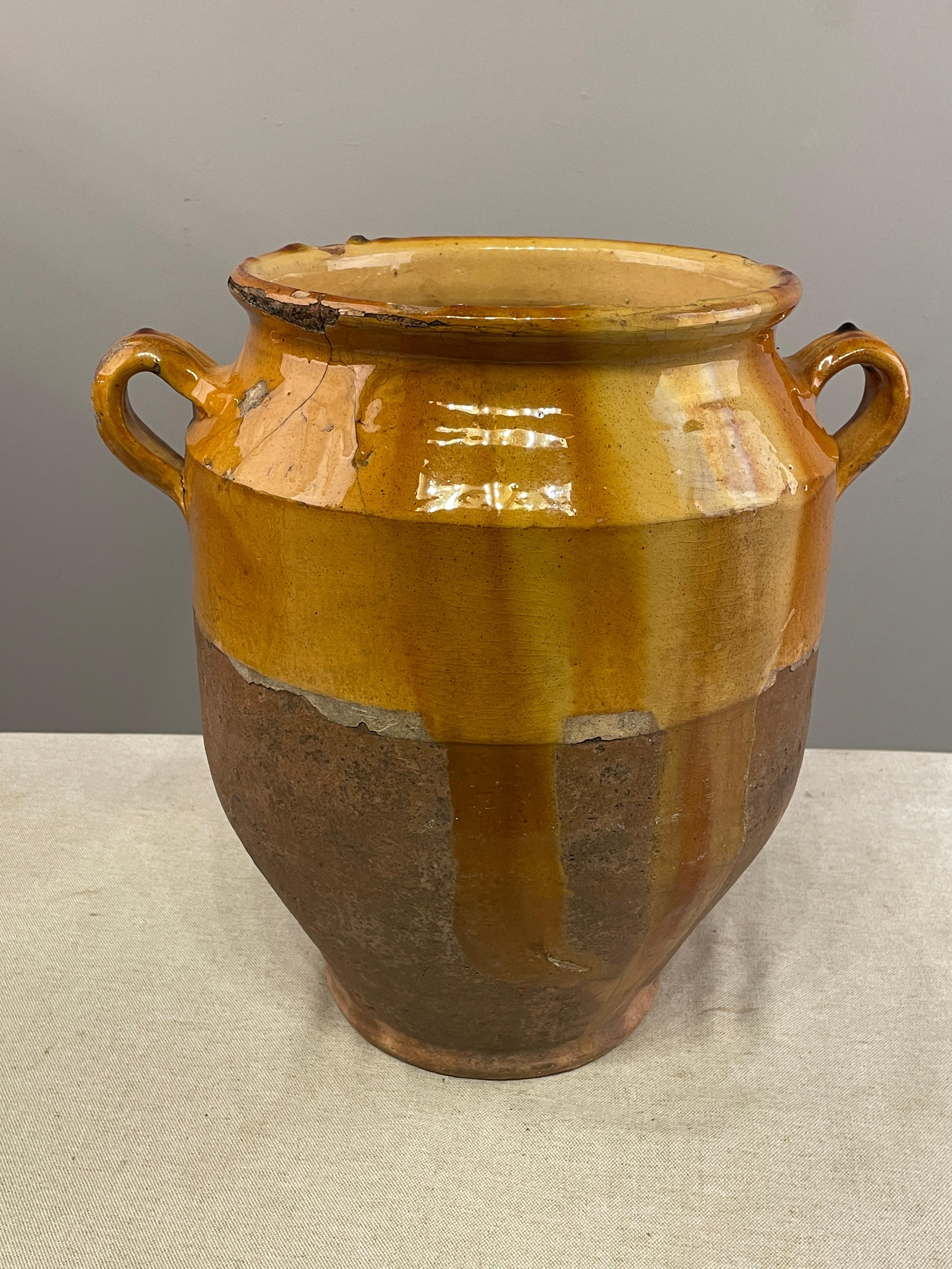 A large earthenware confit pot from the Southwest of France with traditional yellow, ochre glaze. One of the tallest I have ever seen at 14