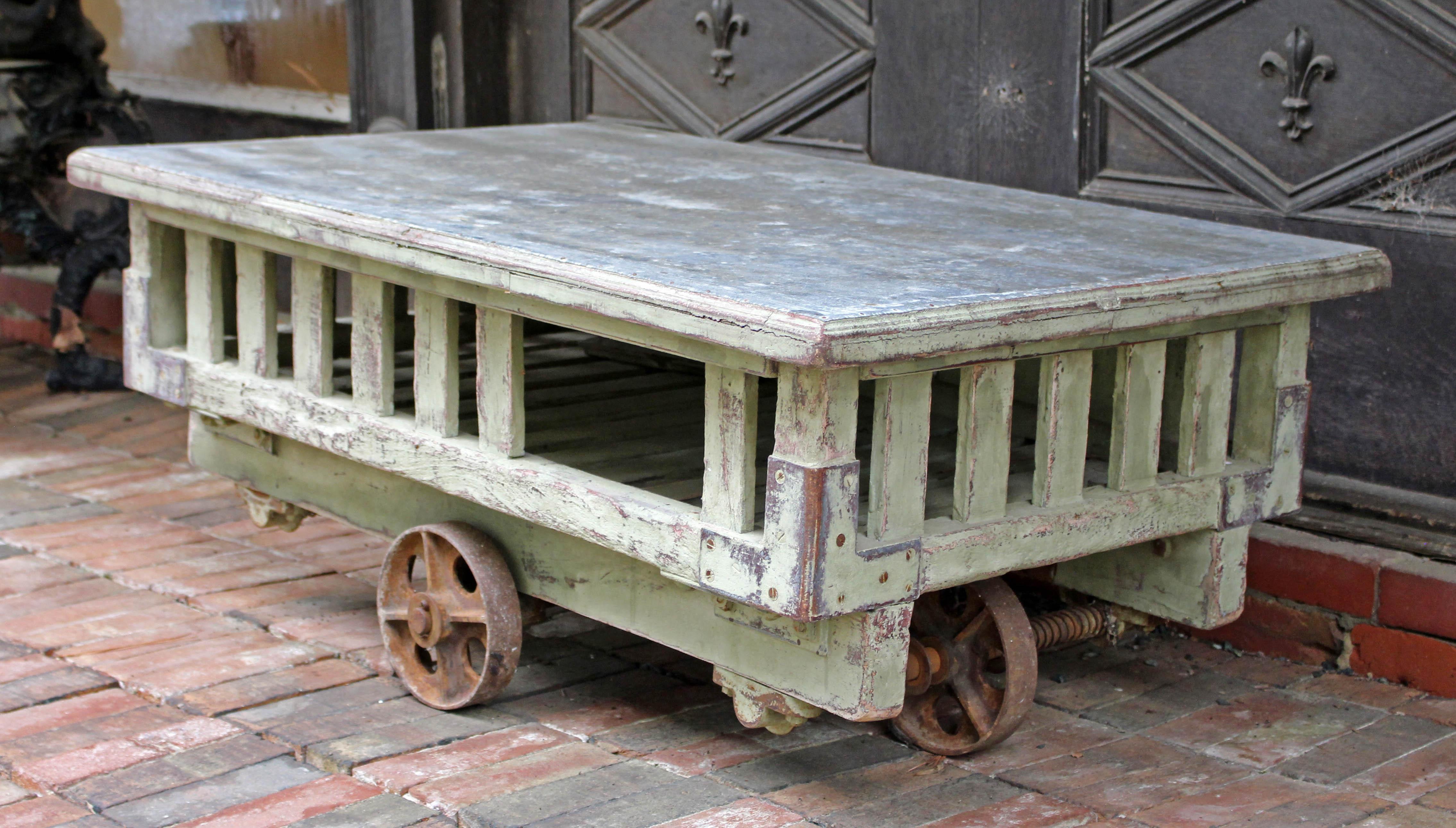 A late 19th century French transport cart with polished steel top of wooden slatted body and iron chassis - now ideal as a fun coffee table. 44 3/4