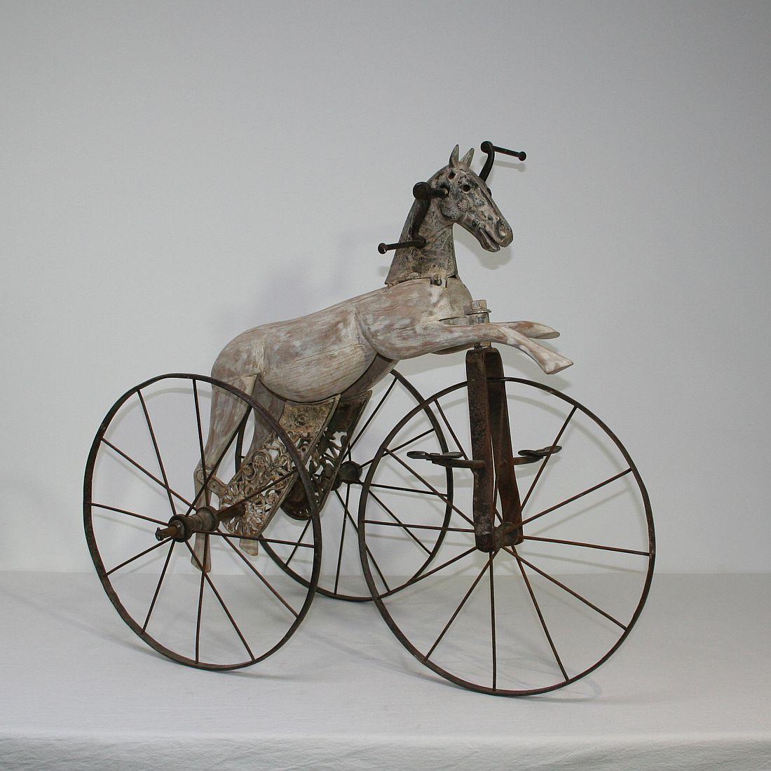 Beautiful and rare wooden tricycle horse with its cast iron details and stunning patina. 

This type of 19th century French velocipede tricycle horse was originally designed by Jean Louis Gourdoux of Paris between 1850 and 1910 which at the time