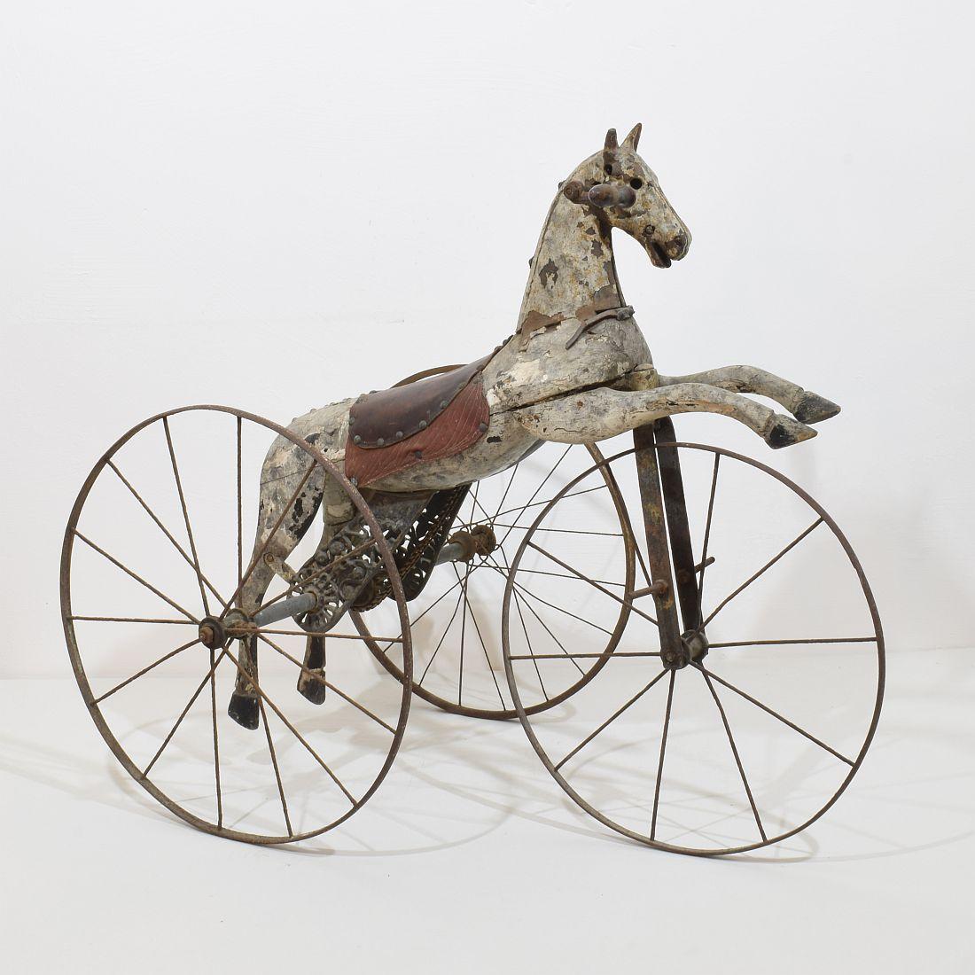 Beautiful and complete tricycle horse with its cast iron details with a stunning patina. Amazing period piece.

This type of 19th century French velocipede tricycle horse was originally designed by Jean Louis Gourdoux of Paris between 1850 and 1910