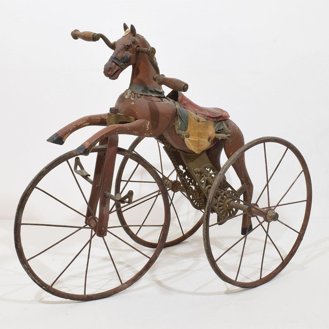 Beautiful and complete tricycle horse with its cast iron details with a stunning patina. Amazing period piece.

This type of 19th century French velocipede tricycle horse was originally designed by Jean Louis Gourdoux of Paris between 1850 and 1910