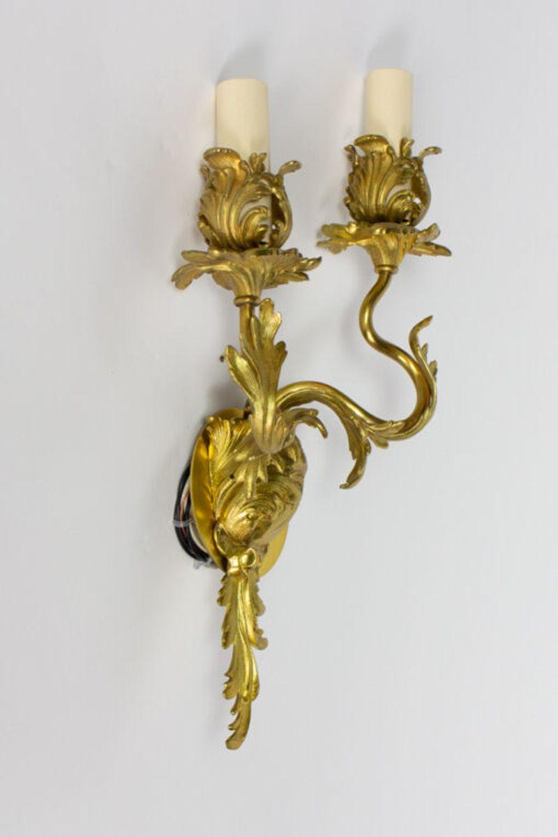 Two arm sconce, rococco.

Material: Bronze
Style: Rococo,Louis XIV
Place of Origin: France
Period made: Late 19th Century
Dimensions: 10 × 6 × 18 in
Condition Details: Excellent Condition, Completely restored and rewired.
