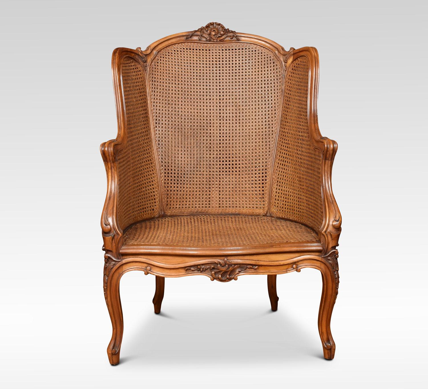 A late 19th century walnut canework wing back armchair, with double canework back and side panels. The finely carved frame raised up on cabriole supports terminating in scrolling toes, together with conforming stool.
Measures: Armchair
Height 41.5