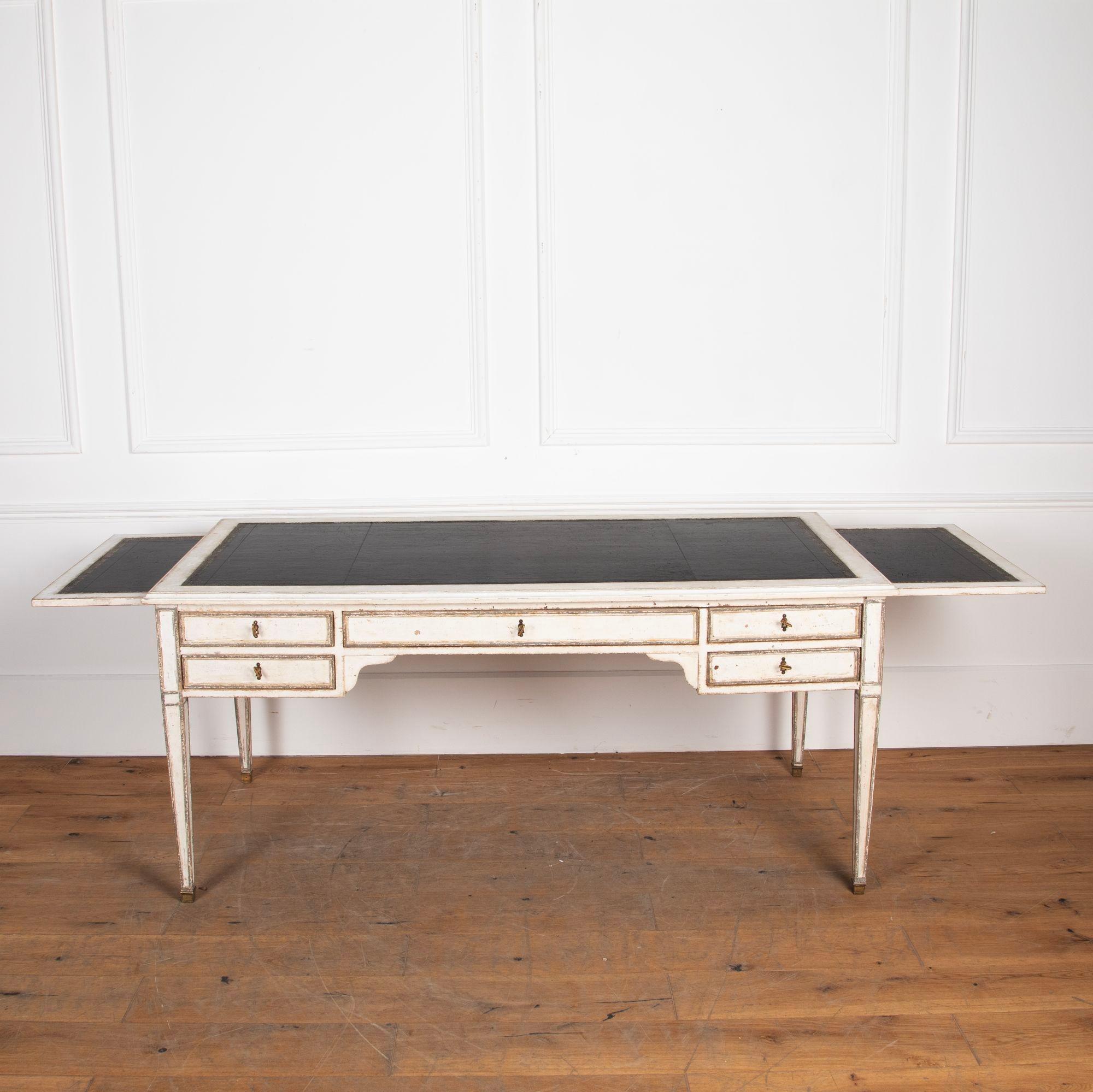 Late 19th century five drawer painted writing desk with inset leather top and two pullout slides.
Standing on tapered legs with brass caps and five dummy drawers on the back.
circa 1890.