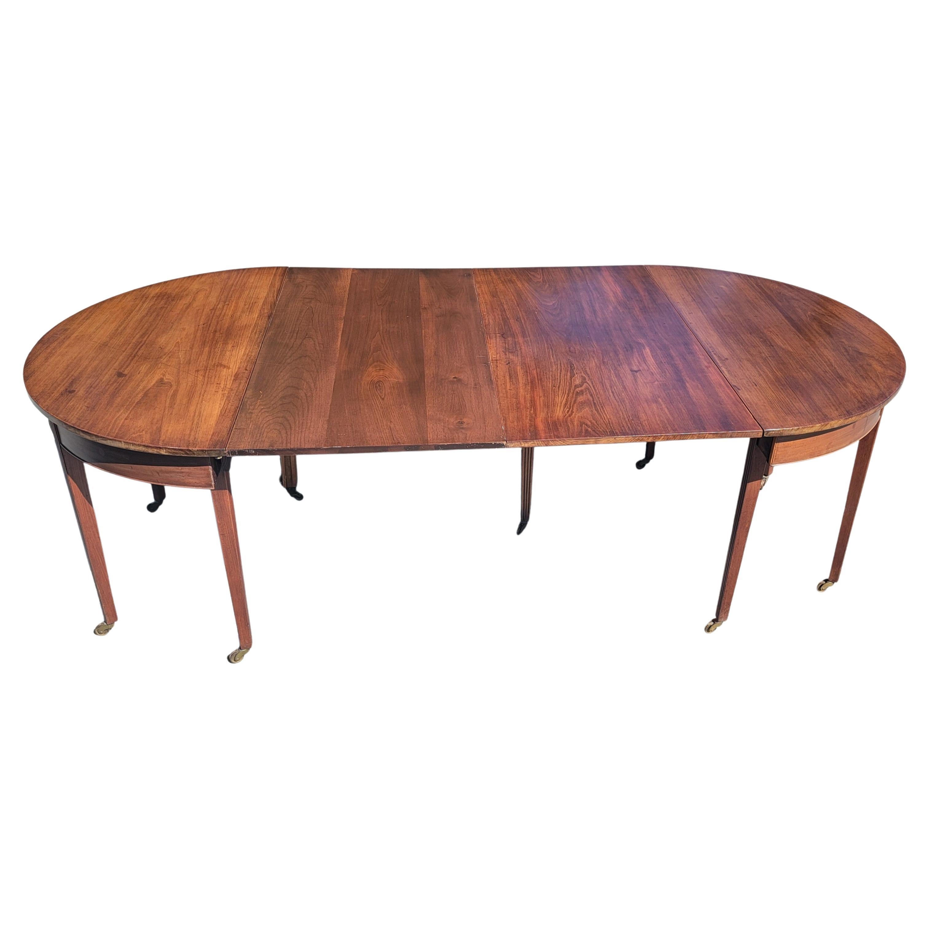 A patinated 10-legged George III style mahogany oval drop leaf extension Dining table on wheels.
Comes with one 24