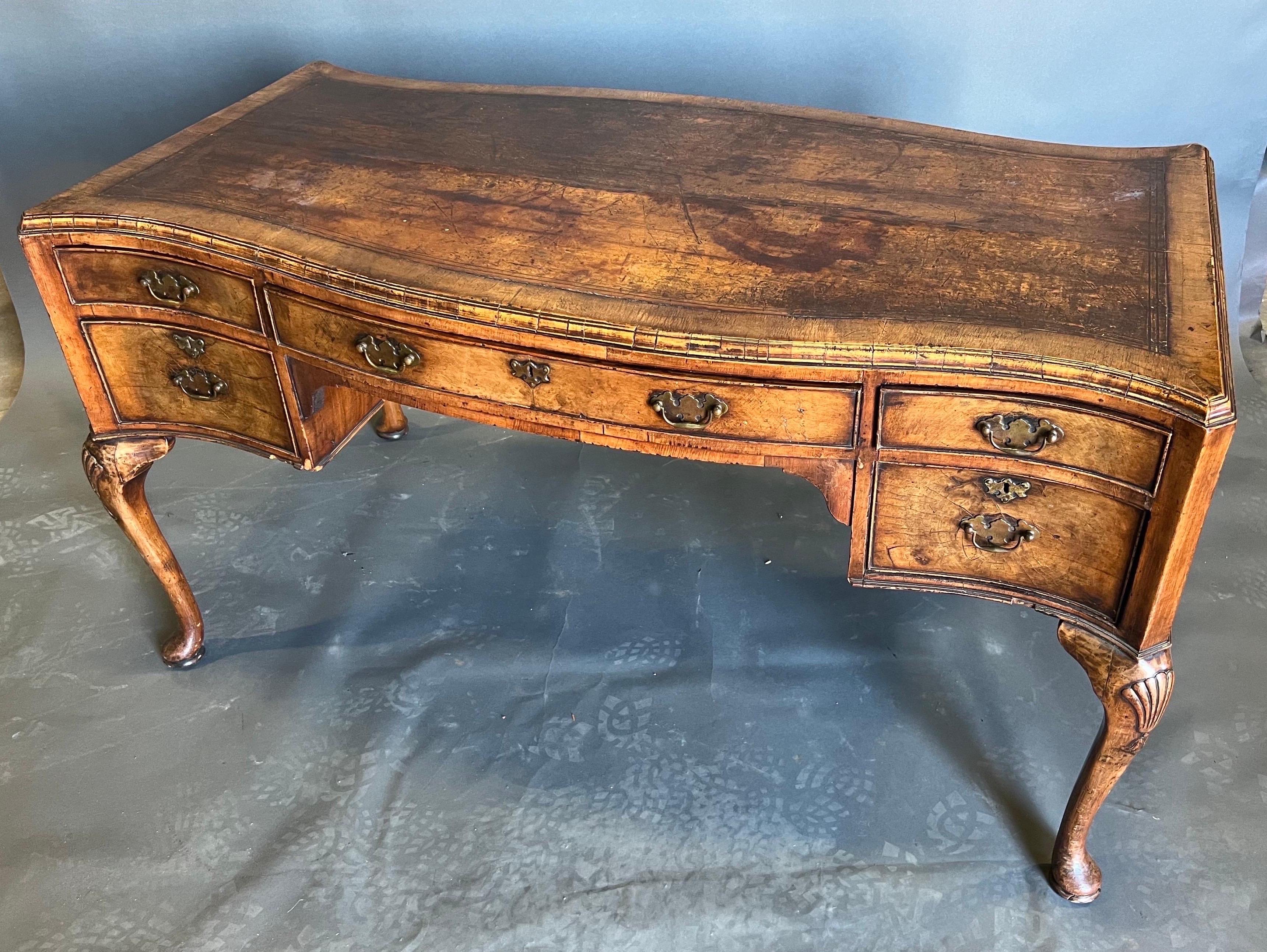 Gorgeous wear and patina on this burl walnut and leather top Georgian style desk from late 19th century. Early Georgian style with burl walnut and leather top raised on pad feet with a 24.25