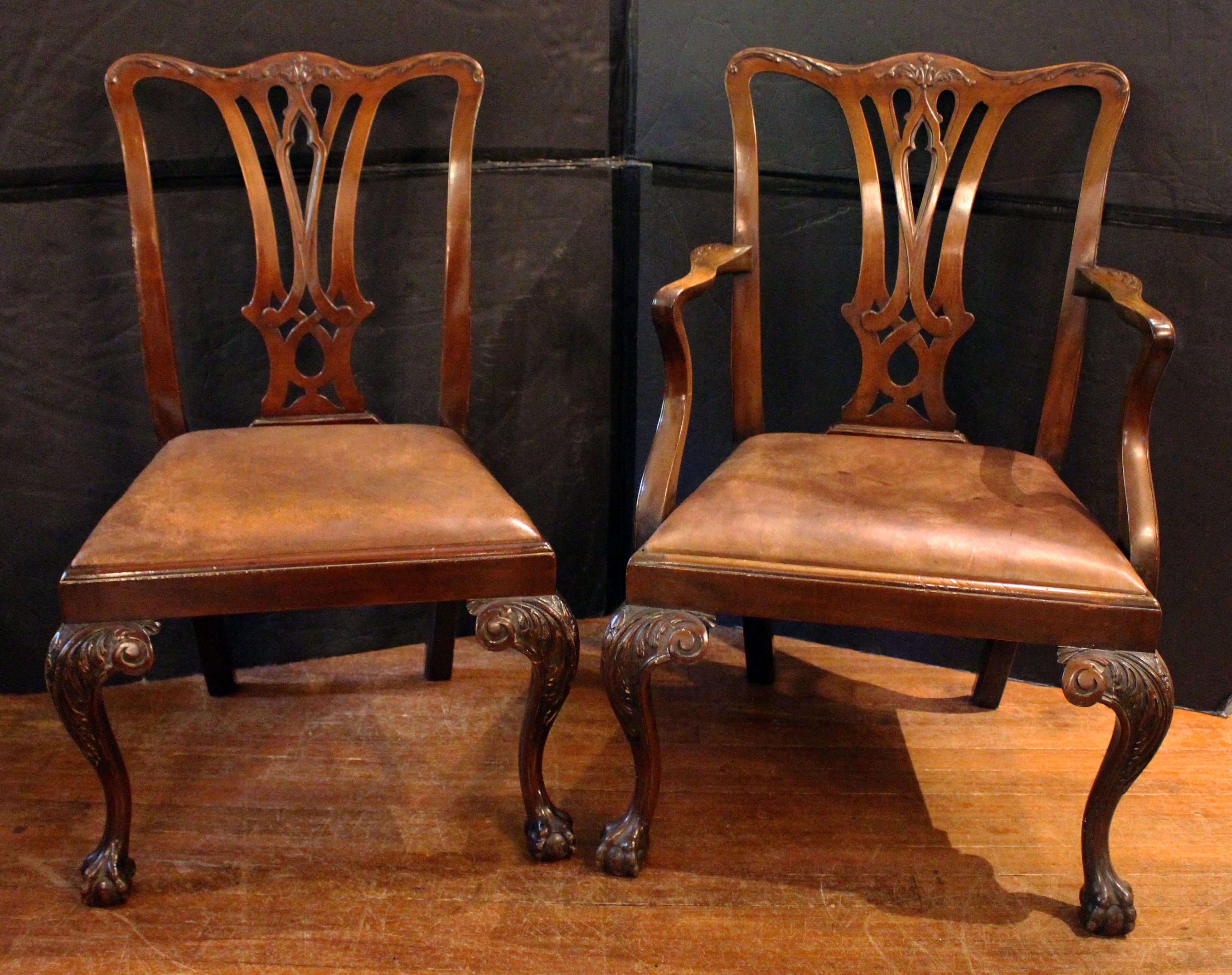Late 19th century Georgian style set of 10 dining chairs, English. Mahogany. 2 arms & 10 sides. Well carved after Chippendale's Gothic taste with Rococo flourishes. Shapely cabriole legs with acanthus carved knees & returns drop gracefully to well